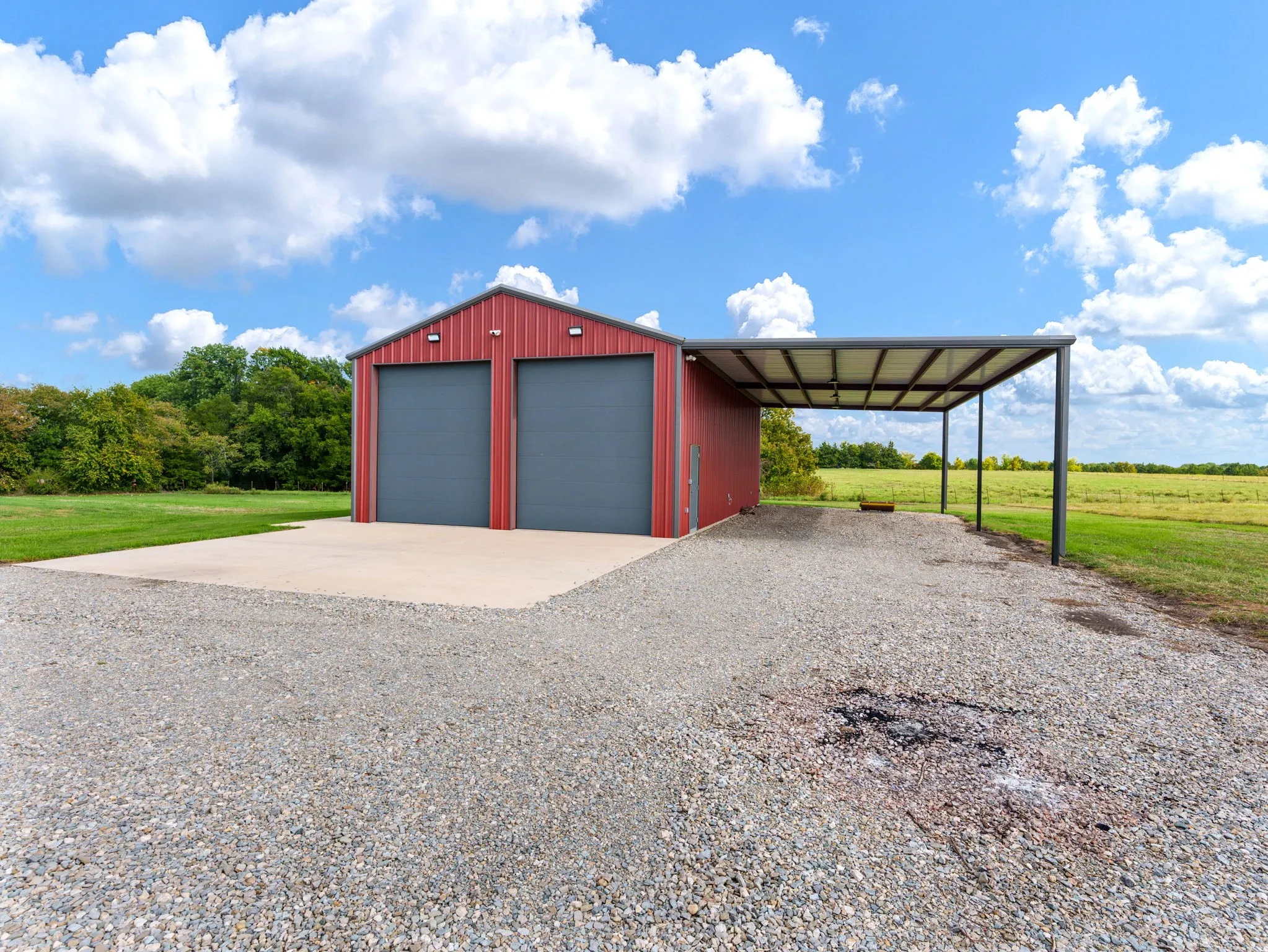 workshop with electric opener doors and additional covered parking or RV storage