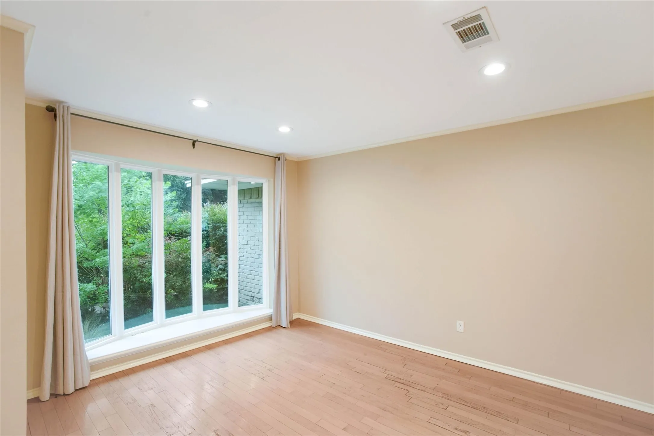 Formal living room with tall windows is light and bright and makes a perfect flex space