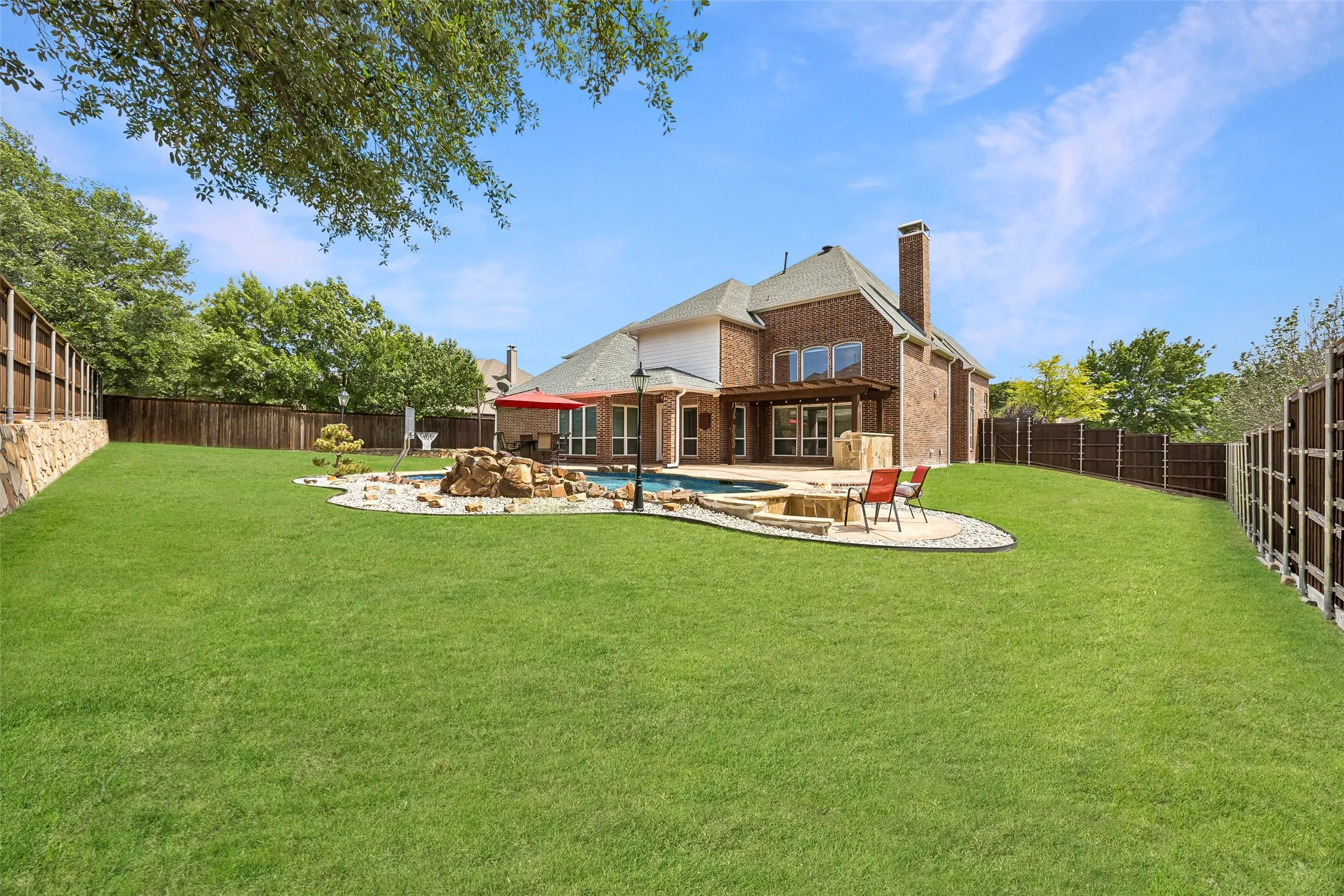 Expansive backyard with a sparkling pool, fire pit,
pergola-covered patio, and generous grassy play space, creating the ultimate setting for outdoor living and entertaining.