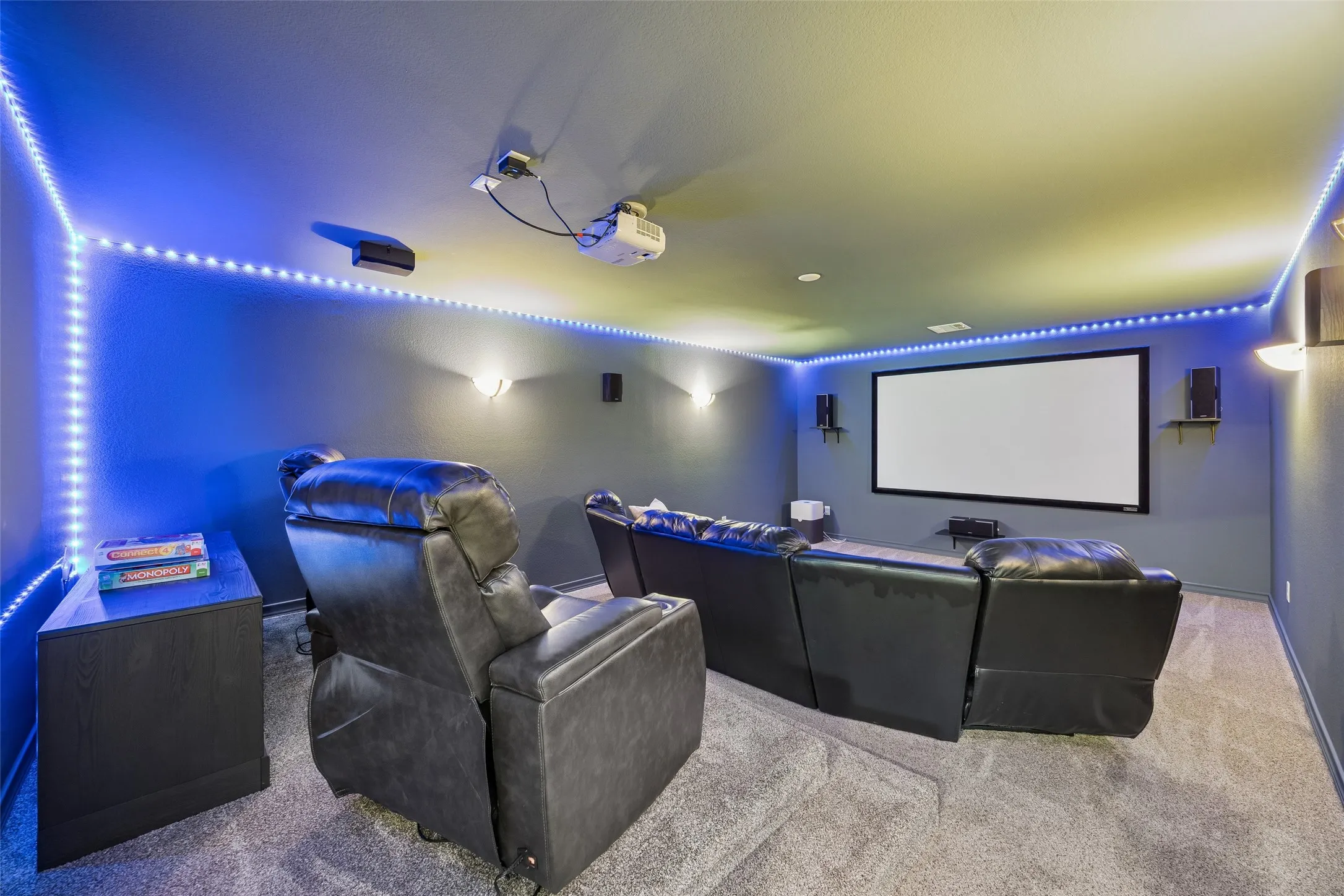 Dedicated media room with projector and large
screen, creating the perfect space for movie nights, game days, and entertaining.