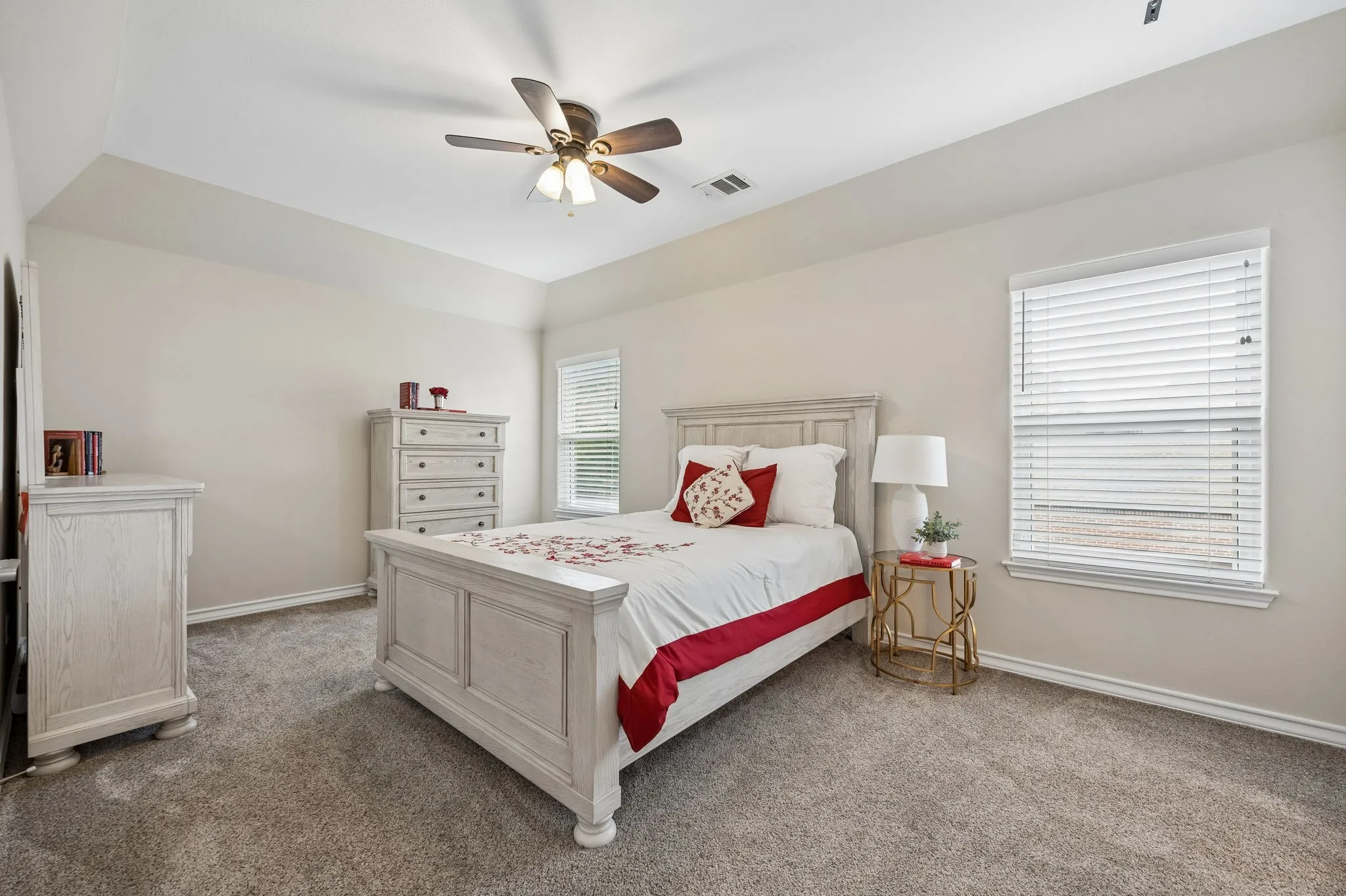 Spacious secondary bedroom with vaulted ceilings,soft natural light, and generous space for guests or everyday living.