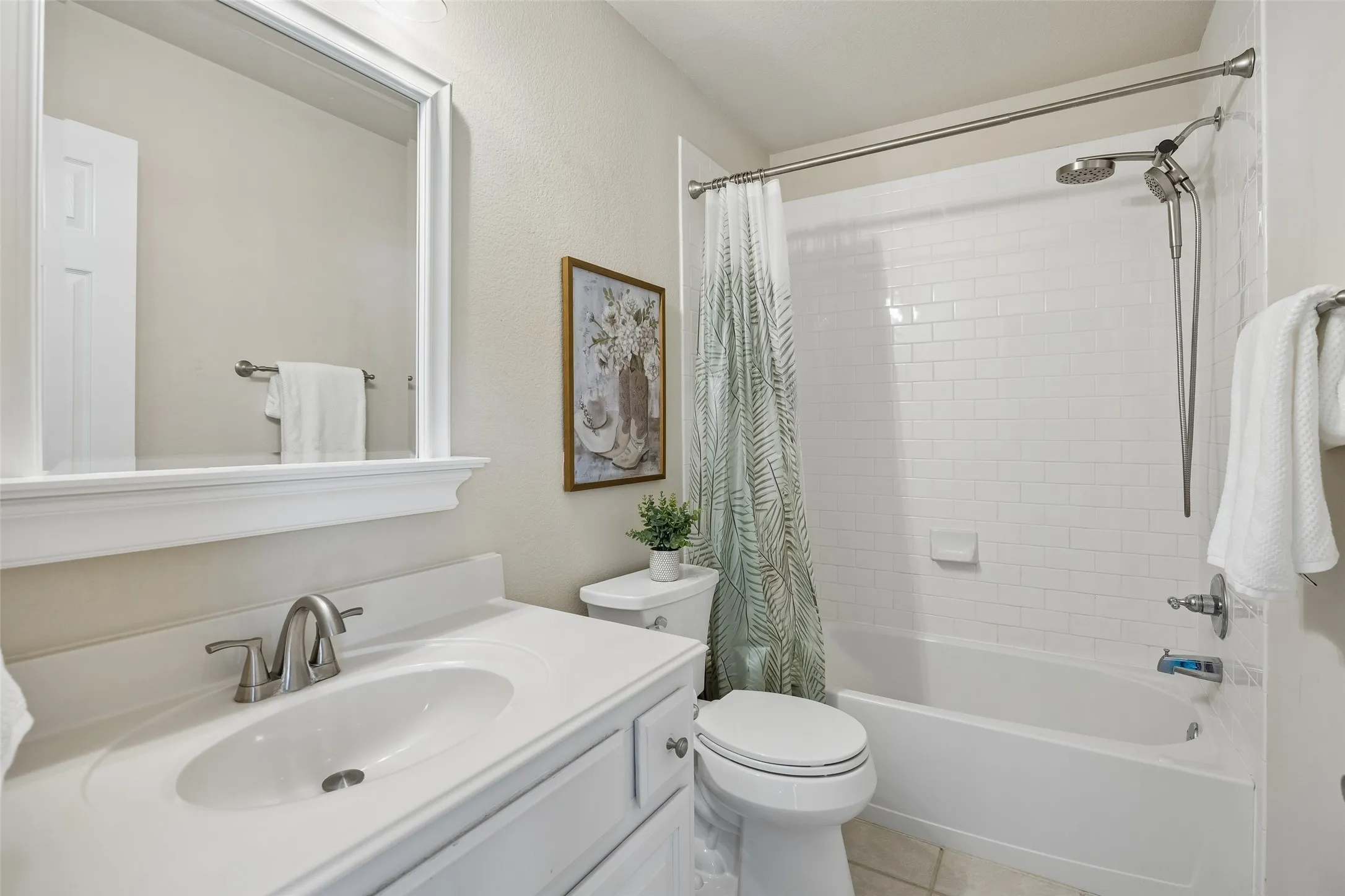 Updated secondary bath with crisp white finishes
and subway tile surround, offering a clean, timeless feel.