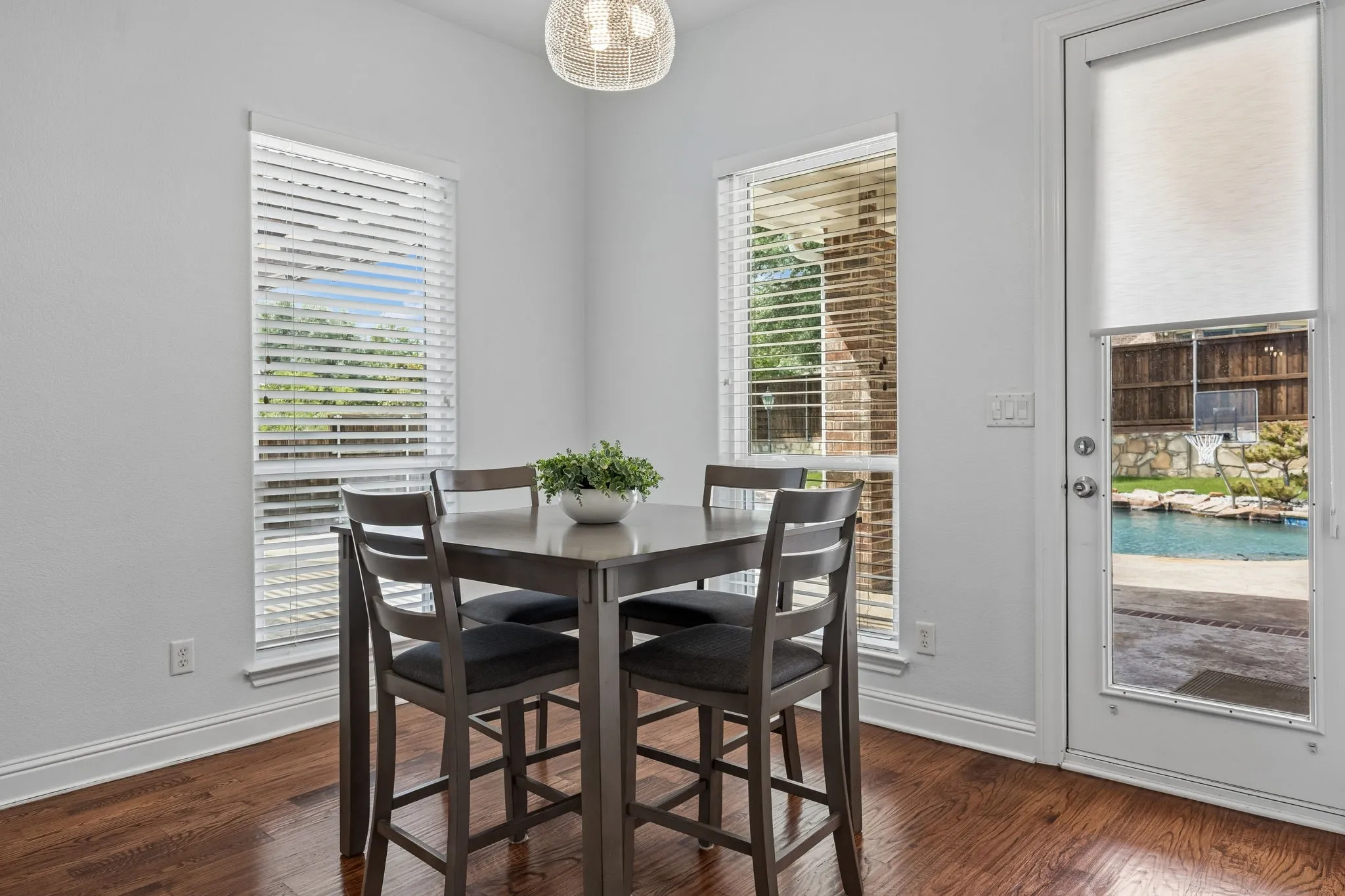 Bright breakfast area with wood floors and pool views, offering easy indoor-outdoor access for
everyday living and entertaining.