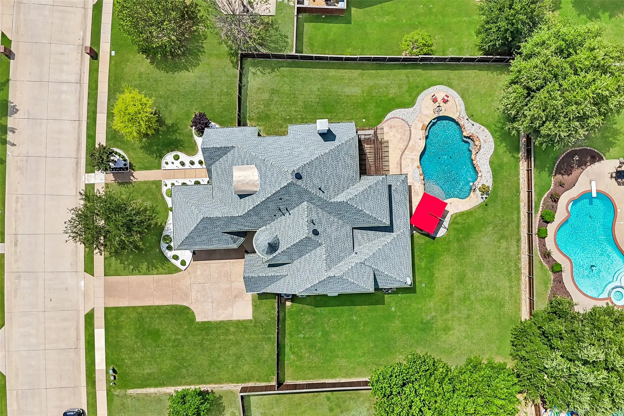 Aerial view showcasing the expansive lot and
resort-style backyard, nestled within the sought-after Lakes of La Cima neighborhood, complete with a sparkling pool and generous outdoor living
space.