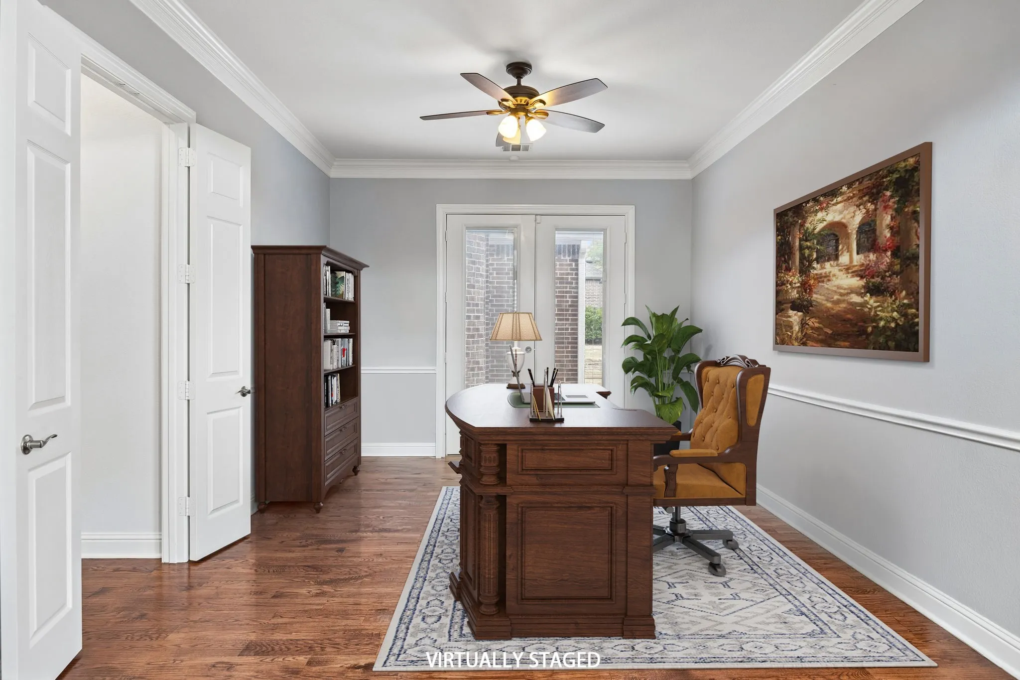 Spacious office with rich wood floors, crown
molding, and French doors.