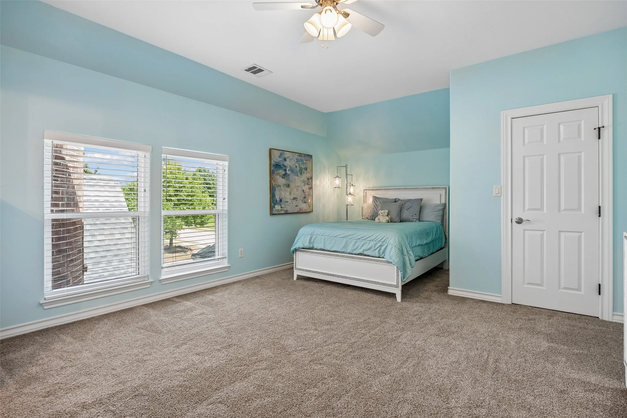 Spacious secondary bedroom with abundant
natural light, a private ensuite bath, and a walk-in closet for added comfort and convenience.