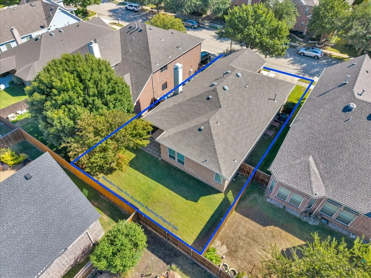 Rear exterior with a pitched roof, brick siding, and a grass lawn