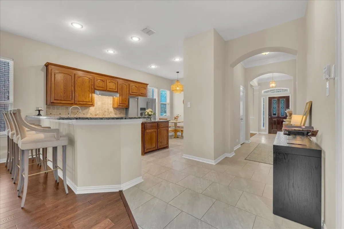 Kitchen featuring wood cabinetry, stainless steel appliances, and recessed lighting
