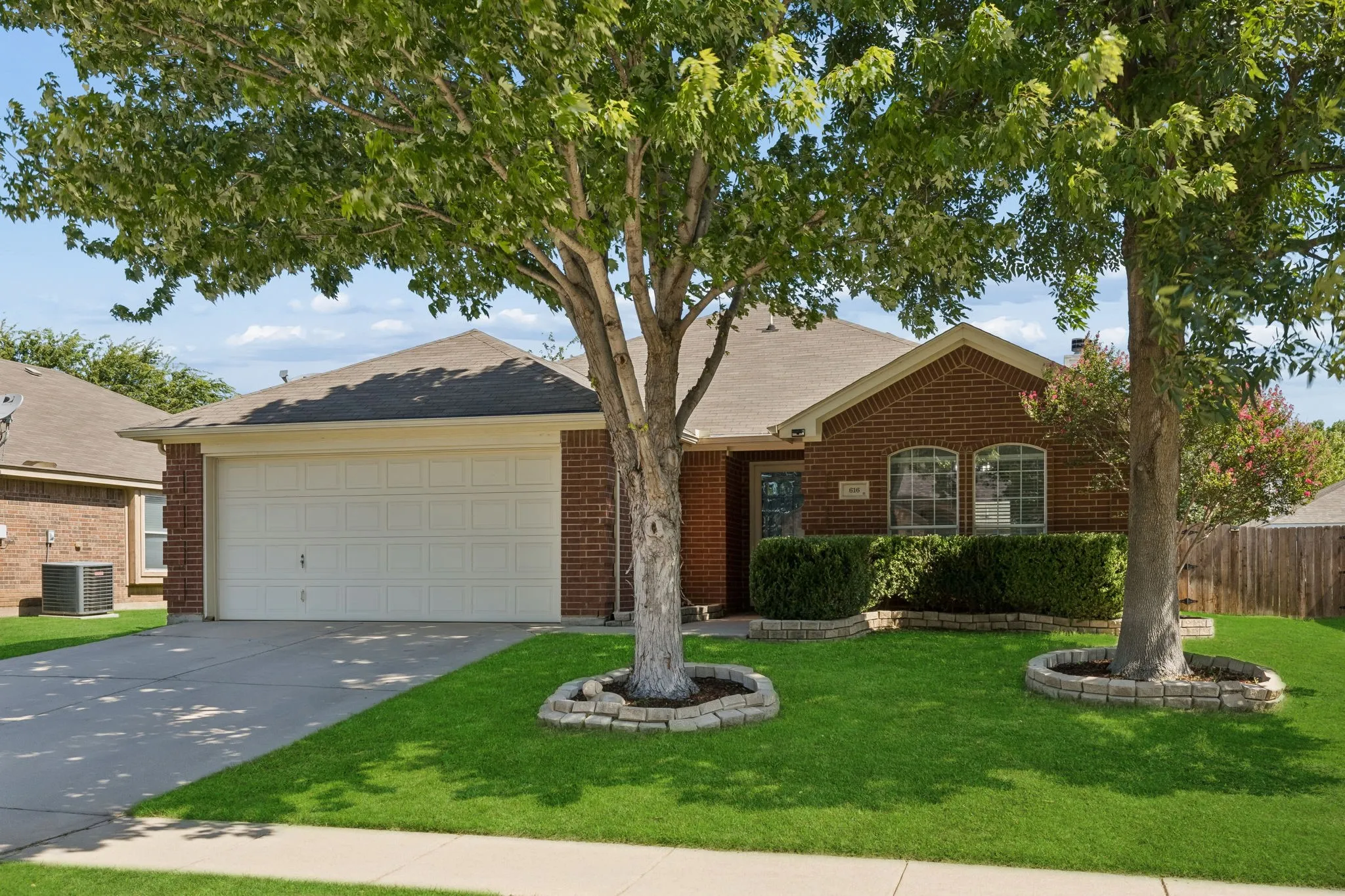 Front of home with matured trees