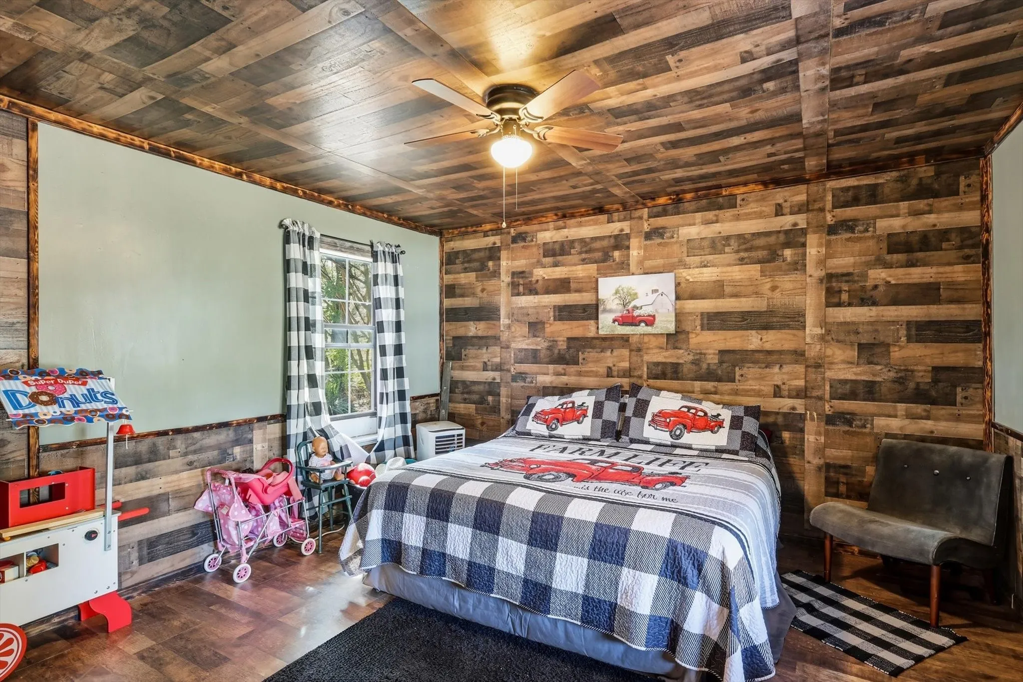 Wood-plank ceiling and accent wall, neutral-toned interior walls, and central ceiling fan