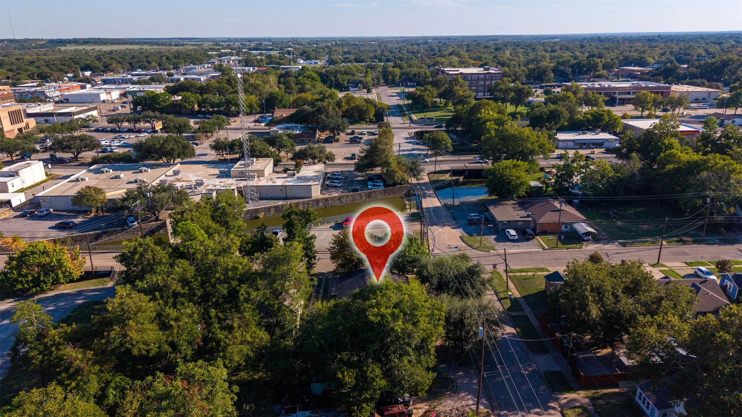 Aerial perspective featuring established mature trees and proximity to local thoroughfares
