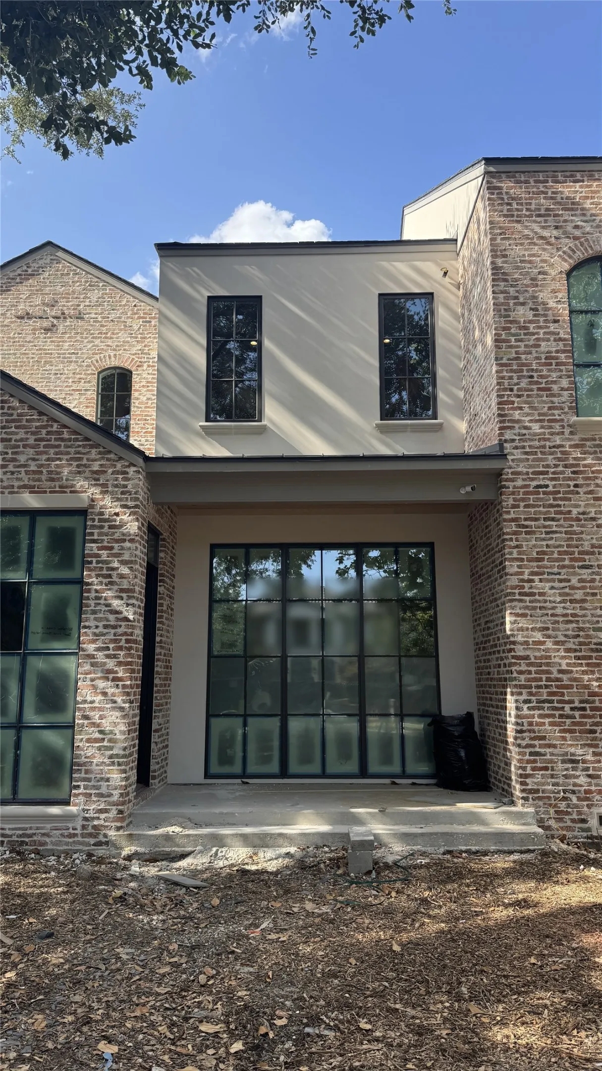 Natural "Chicago Blend" brick with stucco and cast stone accents. Lincoln Bronze aluminum clad windows.