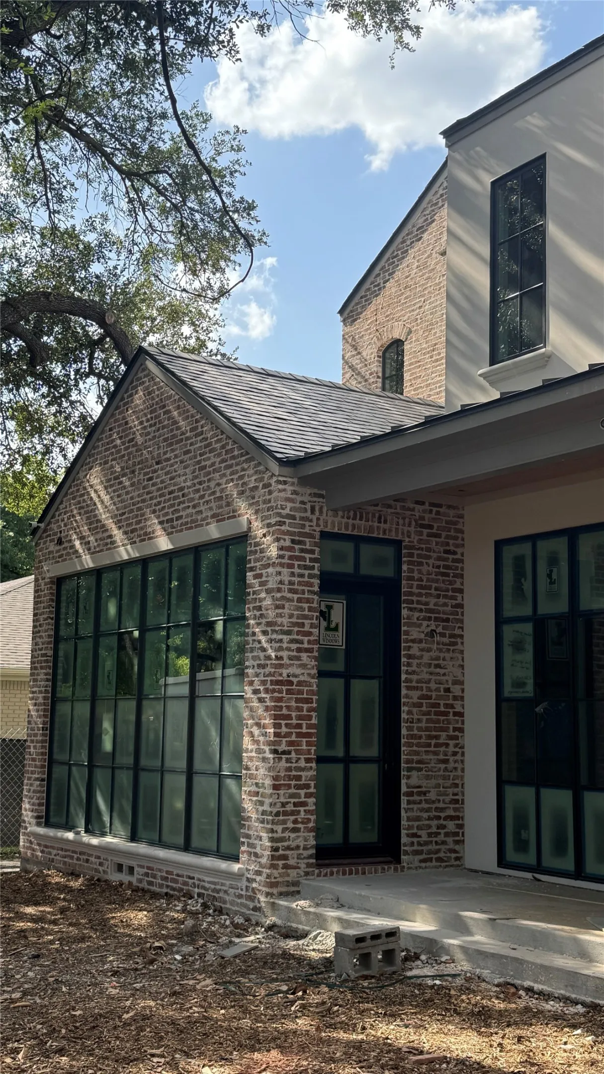 Natural "Chicago Blend" brick with stucco and cast stone accents. Lincoln Bronze aluminum clad windows.
