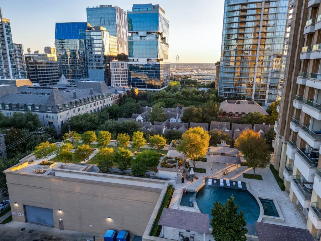 Rooftop green space, multiple pools, established trees, paved courtyards, and urban architecture