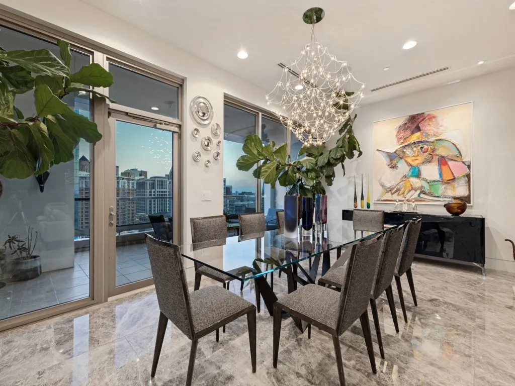 Spacious room featuring large glass sliding doors, recessed lighting, and a unique chandelier