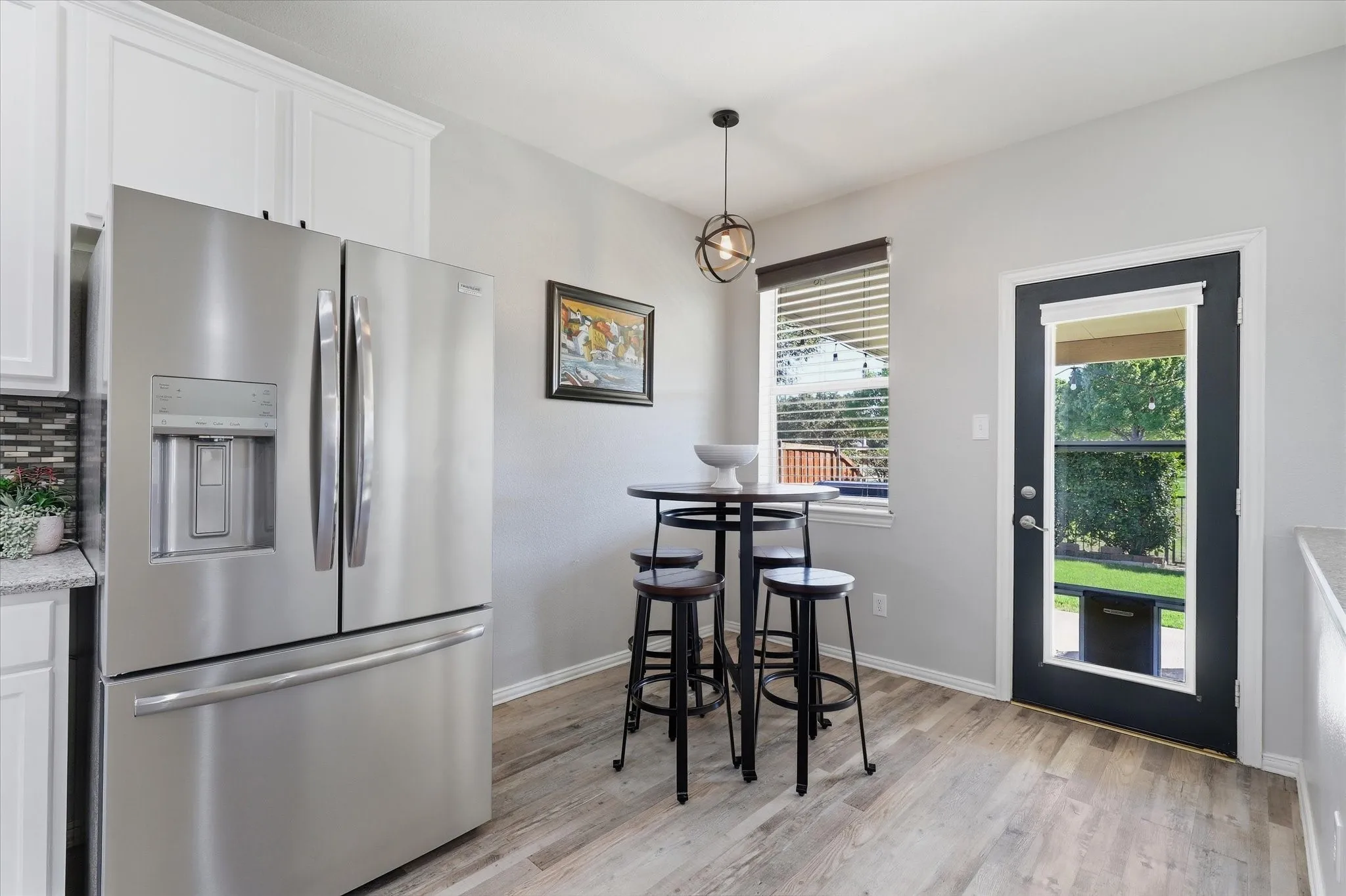 The adjoining breakfast area overlooks the backyard, while the open connection to the family room keeps conversation flowing.