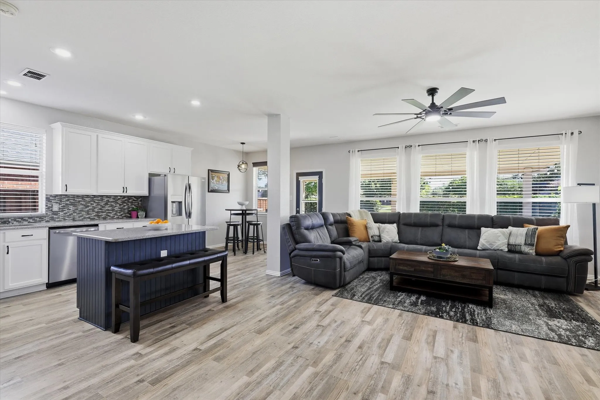 The kitchen opens to the family room, with island seating keeping conversation flowing between the two spaces.