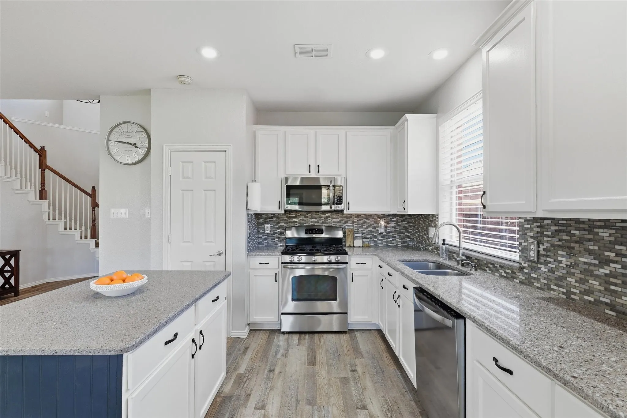A stainless steel gas range, over-the-range microwave & ample preparation space make the kitchen both practical & appealing.