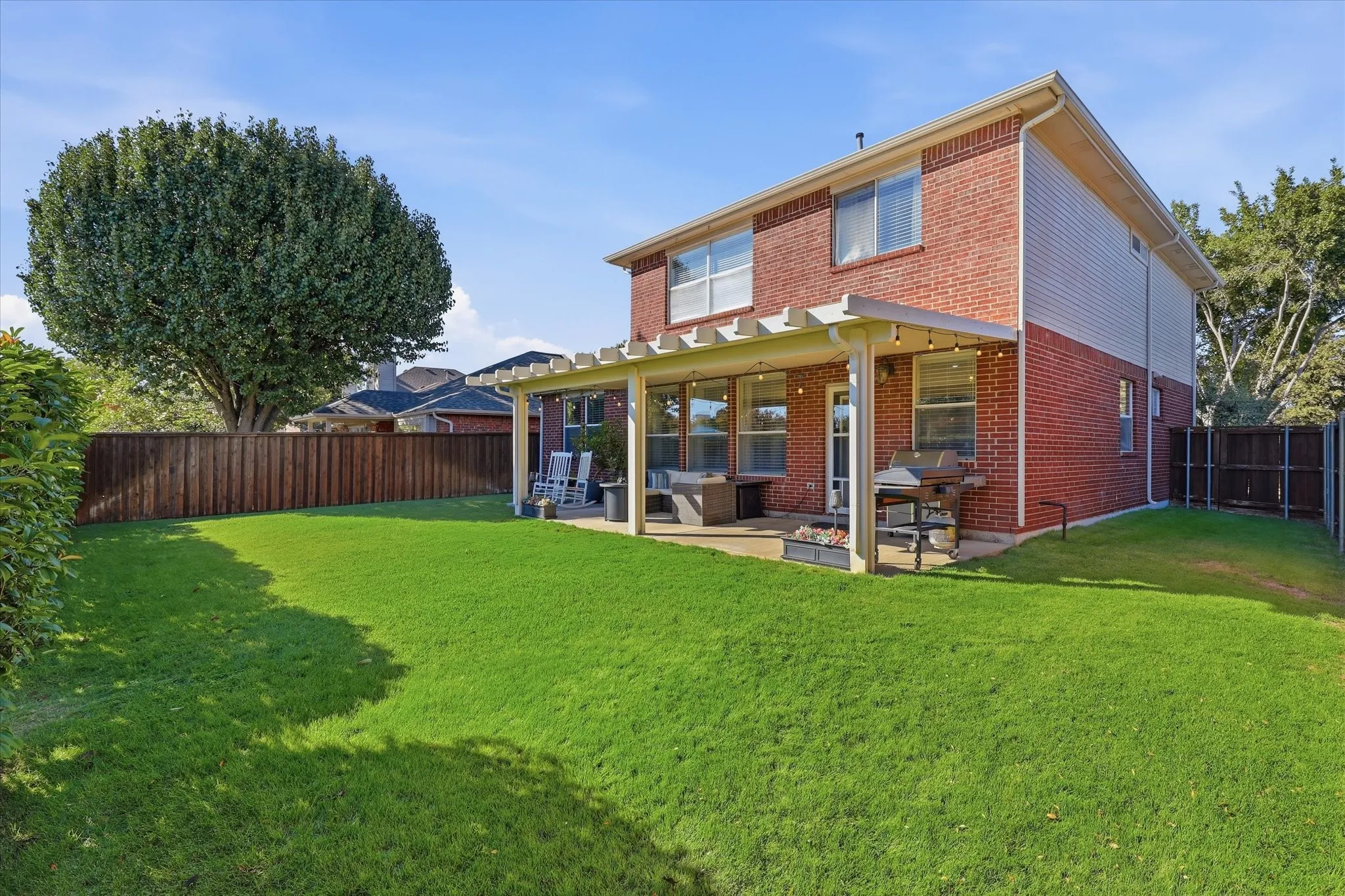 Outside, an extended covered patio provides ample room for lounging, dining & gathering.