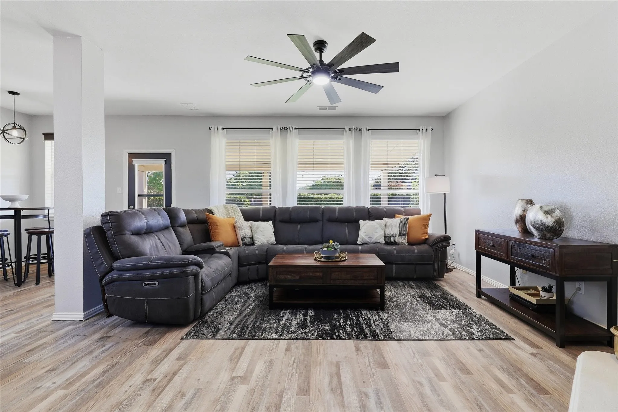 Large backyard-facing windows fill the family room with natural light, creating an inviting space to gather.