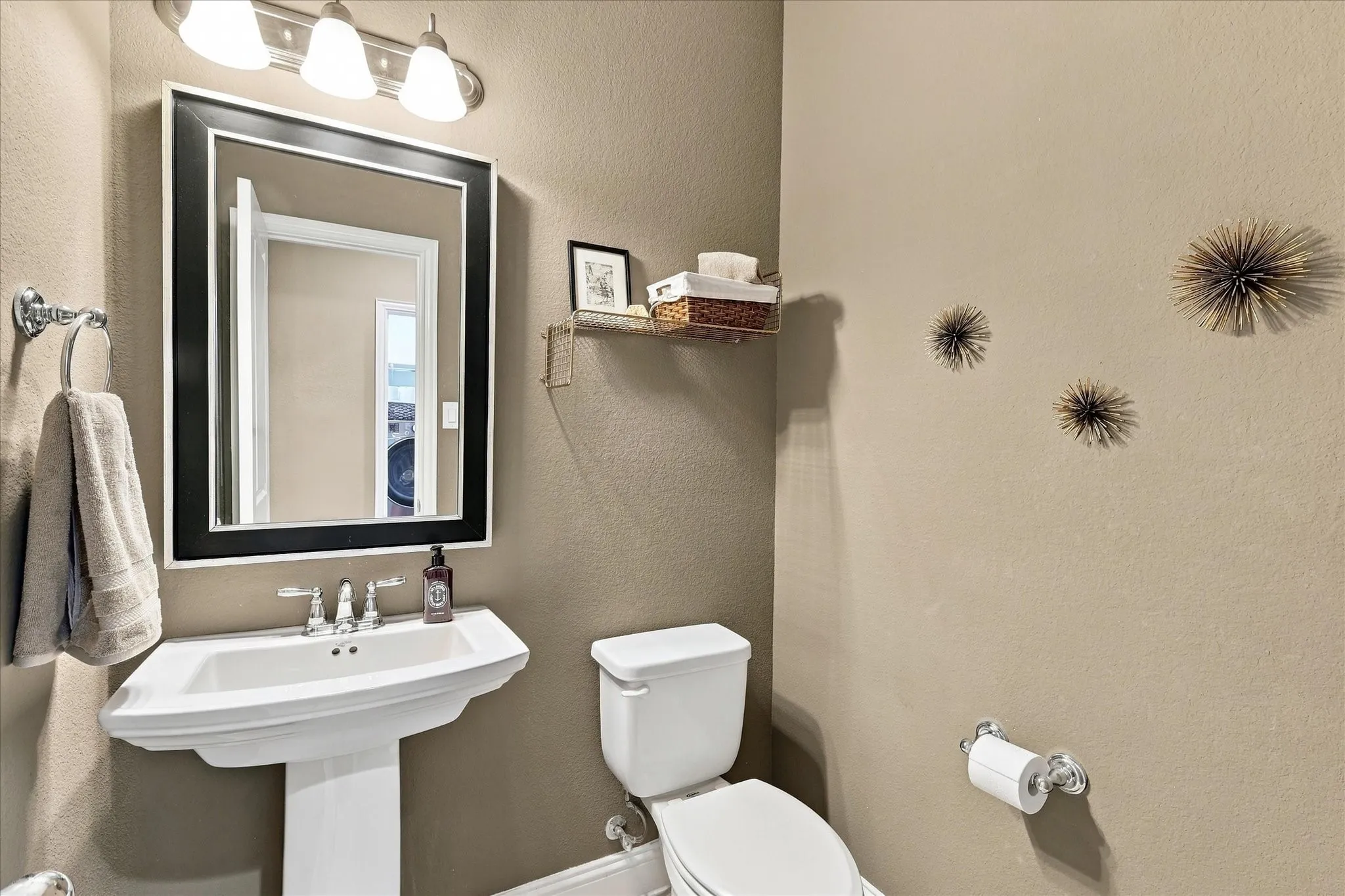 Powder bath by office, with framed mirror and updated paint.