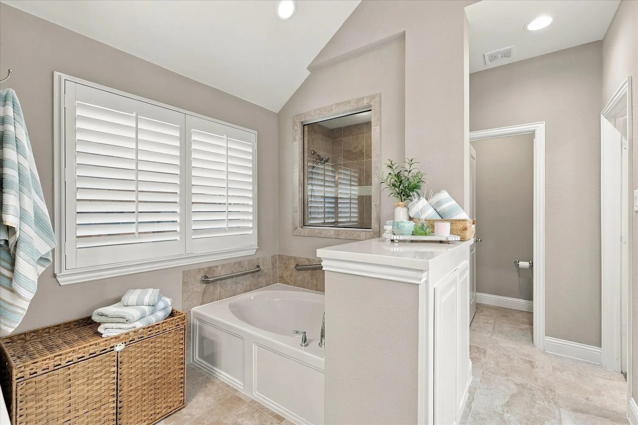 Gorgeous primary with dual separated sinks, make up vanity or sitting area, large soaking tub, walk in shower and massive closet!