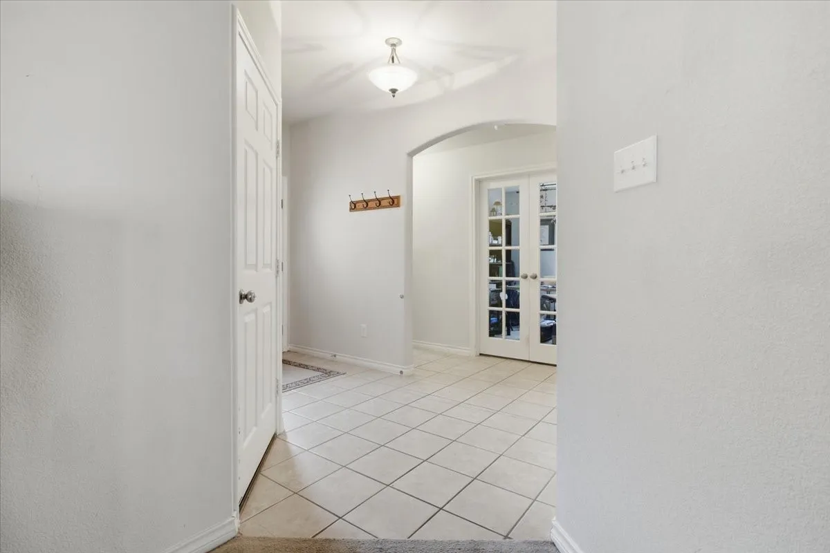 Inside the front entry. The study doors show in the back ground