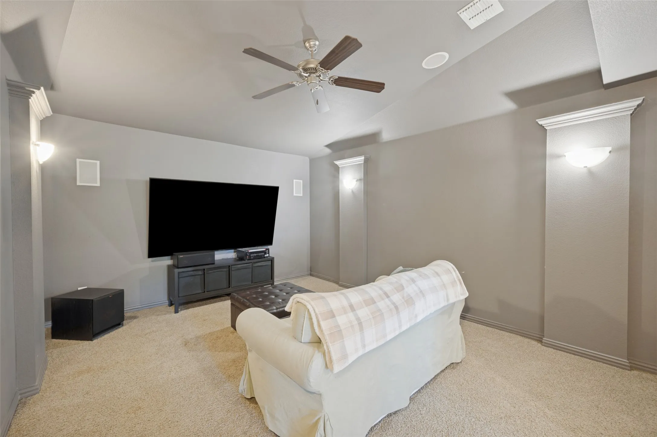 Dedicated media room with a convenient half bath nearby.