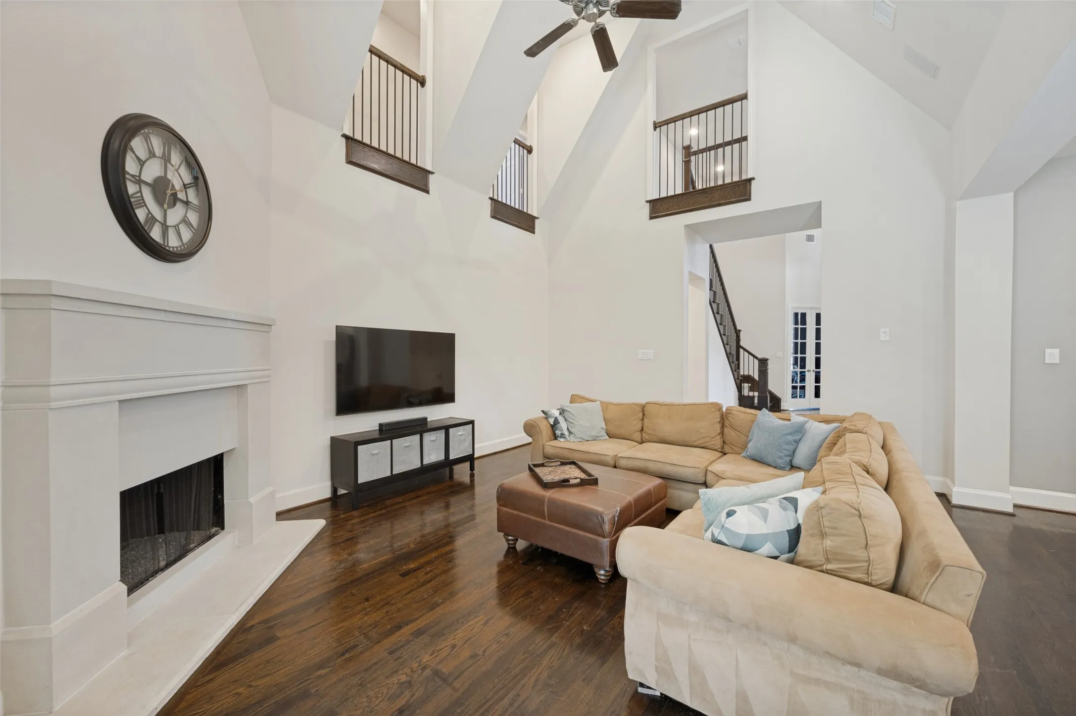 Spacious family room with vaulted ceilings, a gas fireplace and views of the backyard and greenbelt.