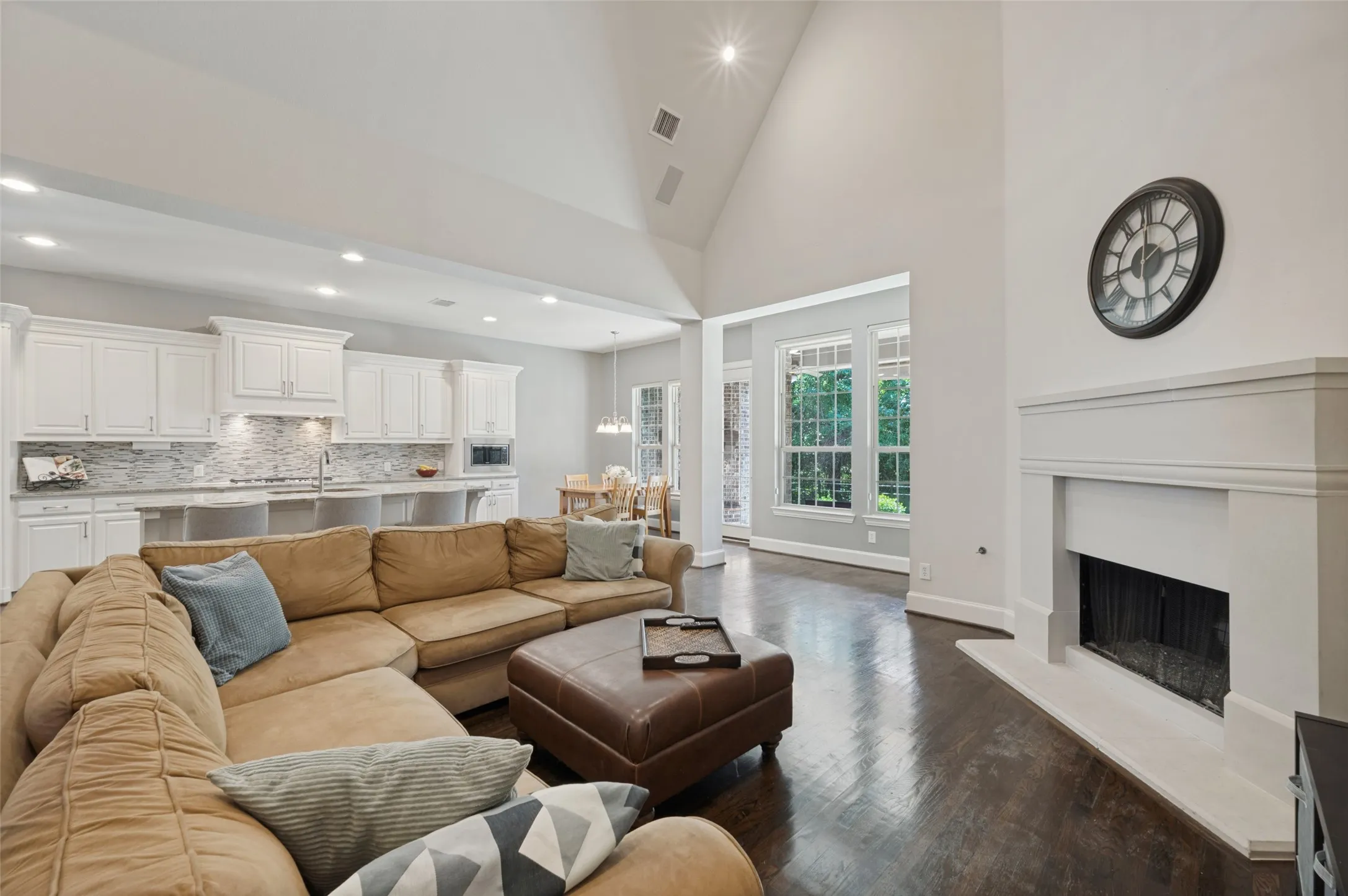 Spacious family room with vaulted ceilings, a gas fireplace and views of the backyard and greenbelt.