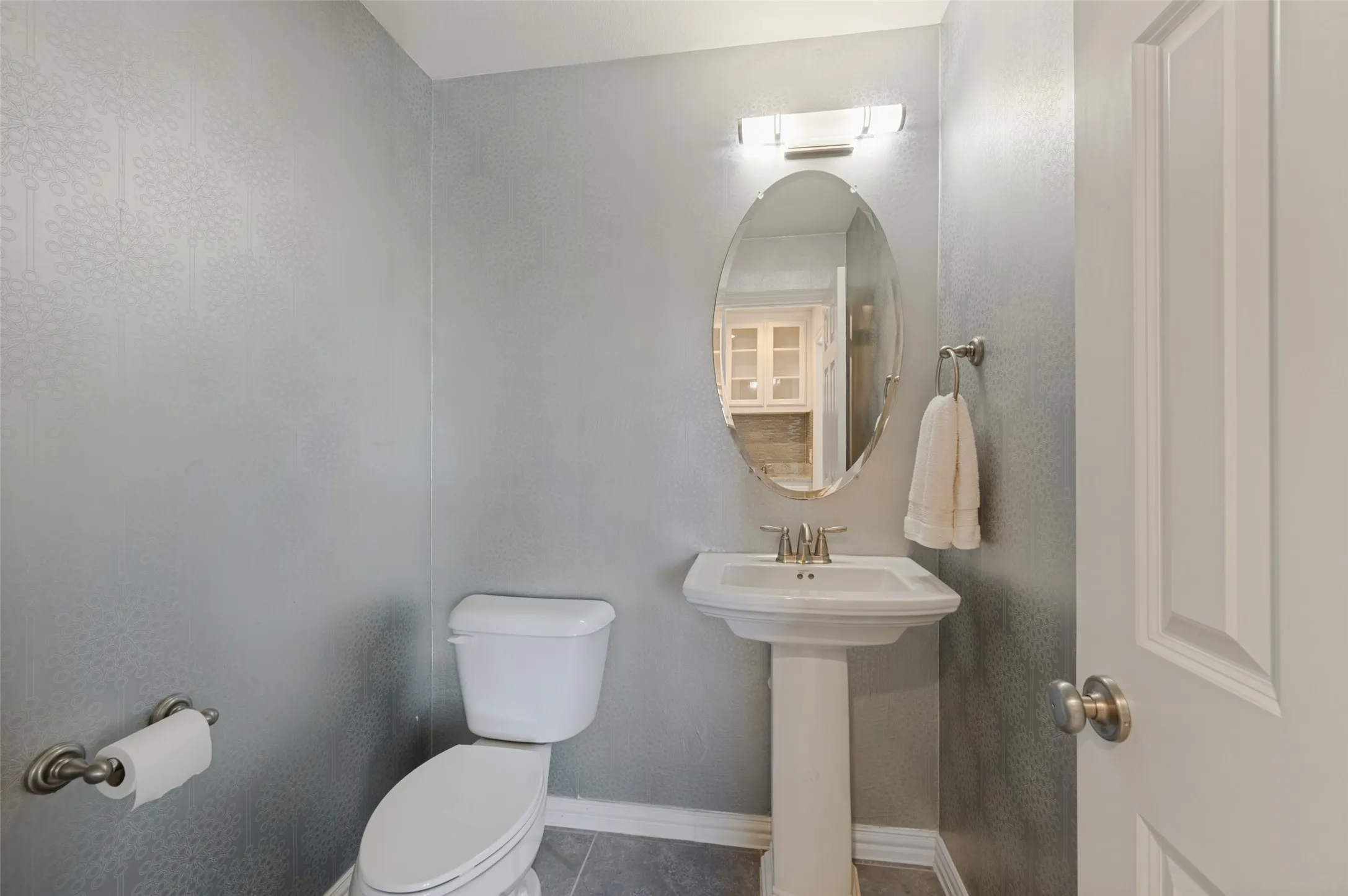 Dedicated media room with a convenient half bath nearby.