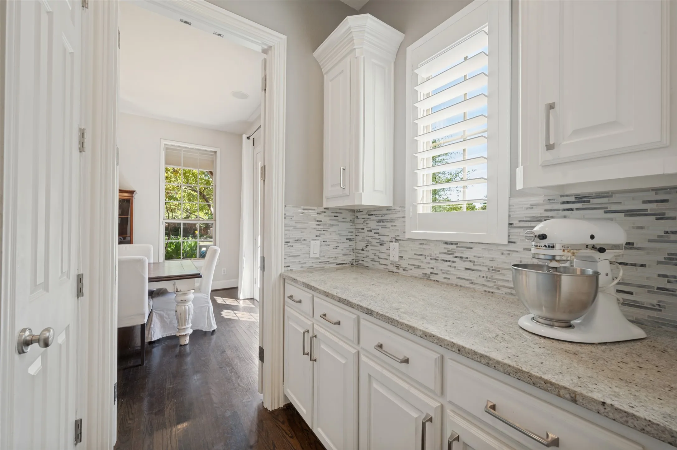 Chef’s kitchen with a large center island, five burner gas cooktop, double ovens, range hood and butler’s pantry.