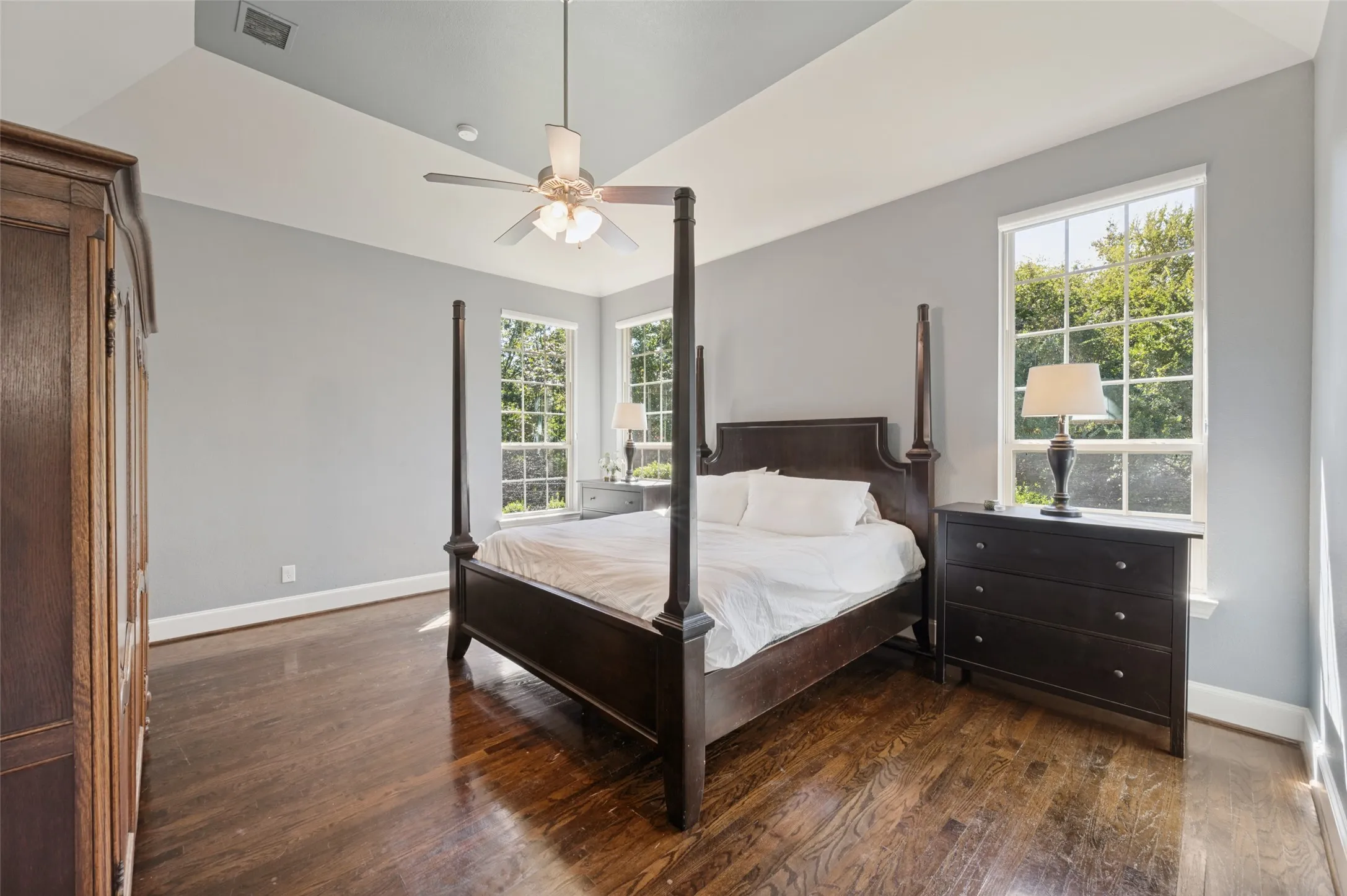 First floor primary suite with generous space and an ensuite bath featuring separate vanities, a soaking tub and separate shower.