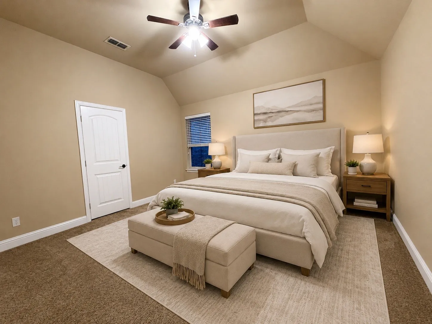Carpeted sleeping area with a vaulted ceiling and a ceiling fan
