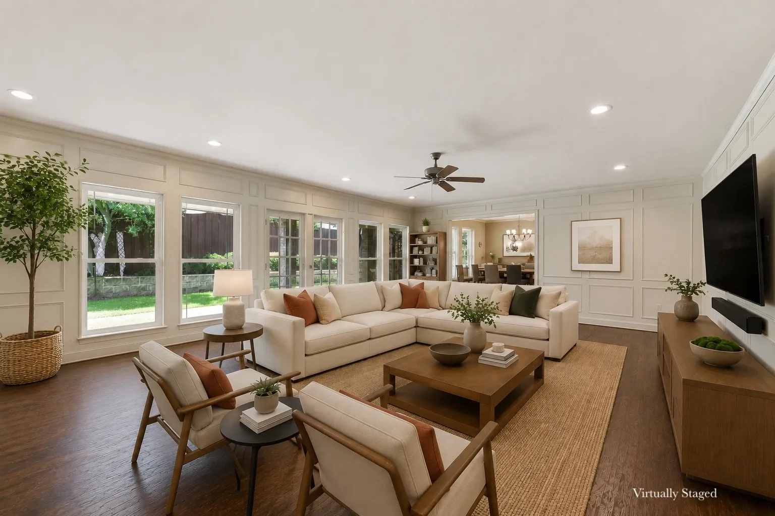 Spacious living area featuring wood-finish flooring, recessed lighting, and a ceiling fan