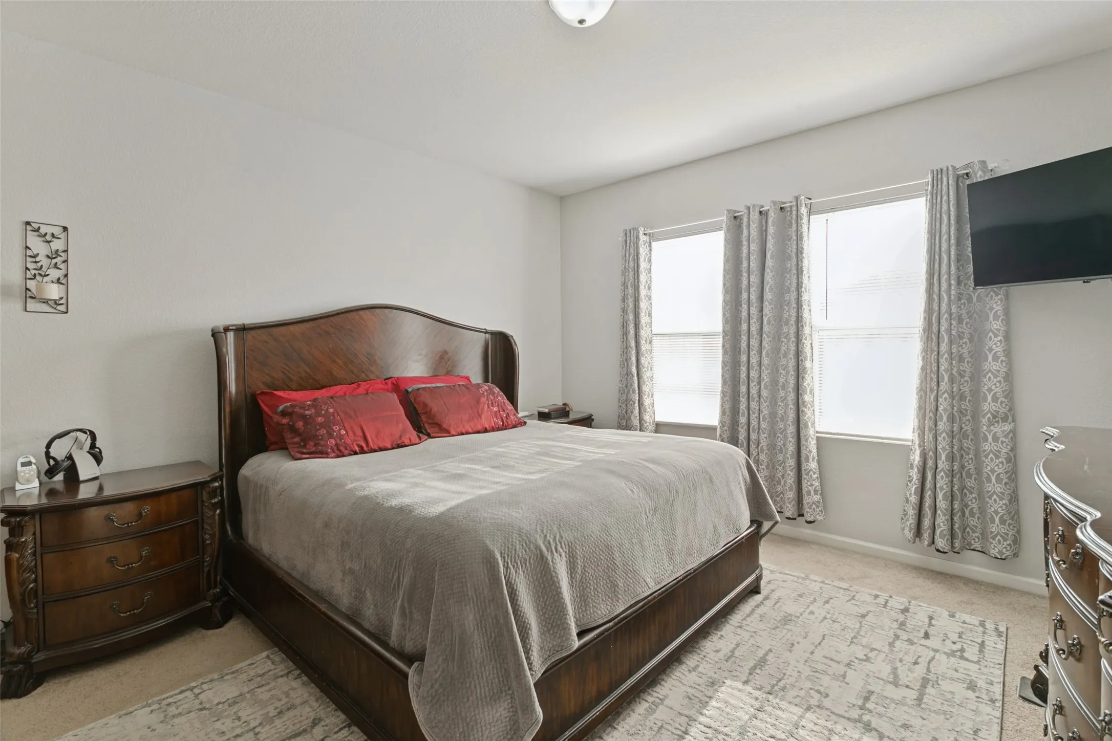 Neutral-toned interior space featuring neutral wall-to-wall carpeting and two dual-pane windows with integrated hardware