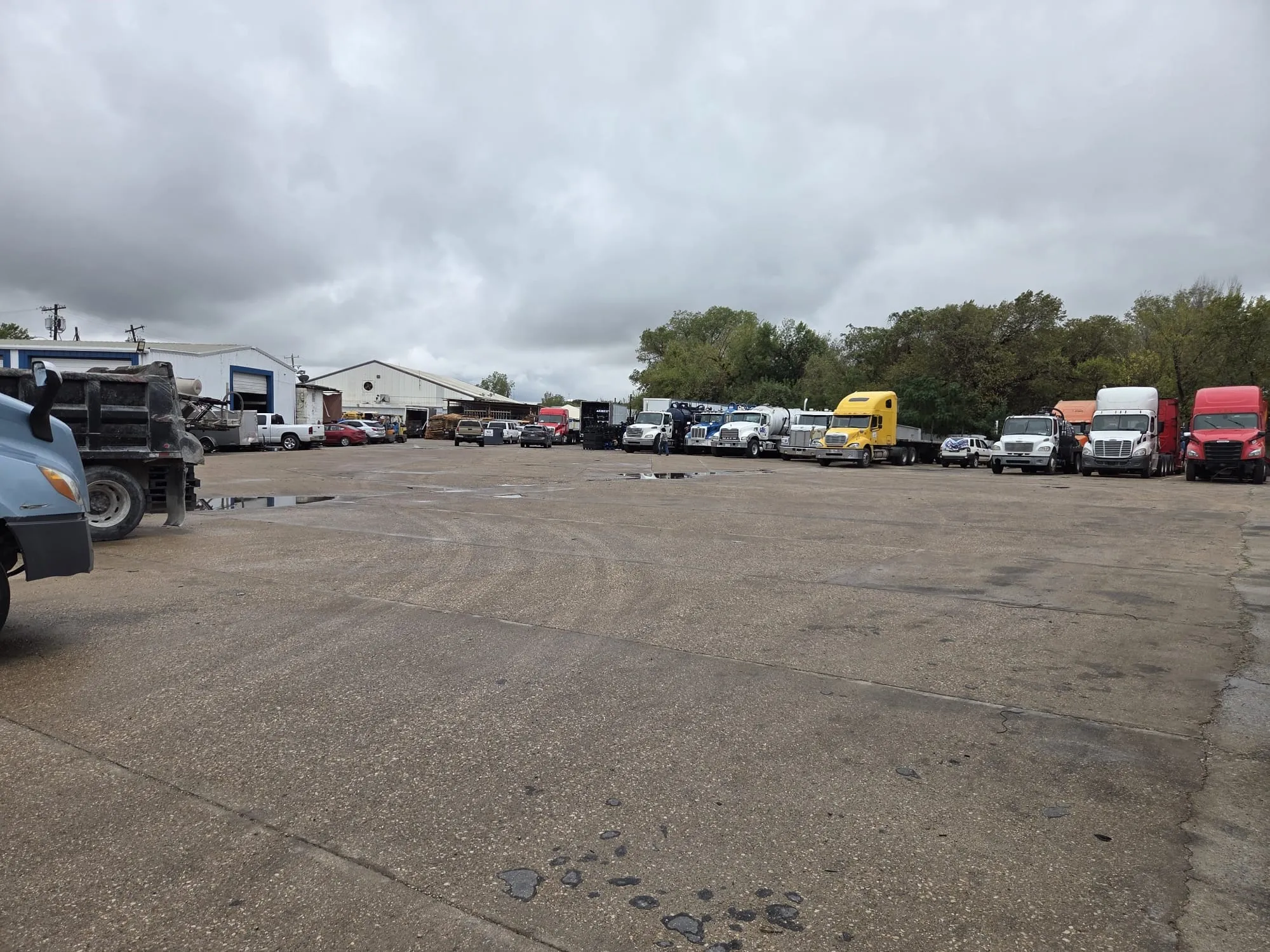 Expansive paved industrial lot featuring multiple metal-clad structures