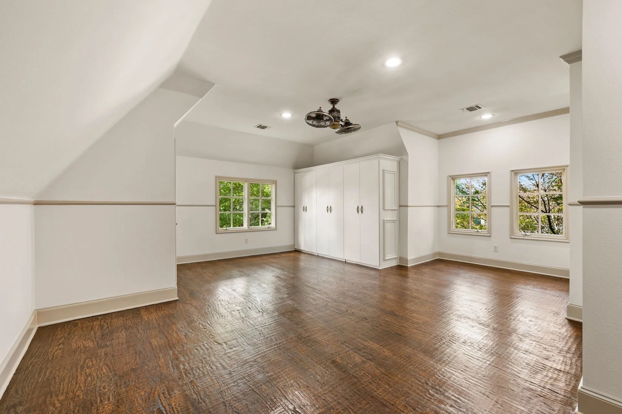This spacious fifth bedroom offers exceptional versatility, featuring a Jack-and-Jill-style bath, walk-in closet, additional built-in cabinetry for storage, and a dedicated sitting area ideal for a desk or gaming space. Its generous size and flexible layout make it perfect for a bedroom, home office, or multipurpose retreat.