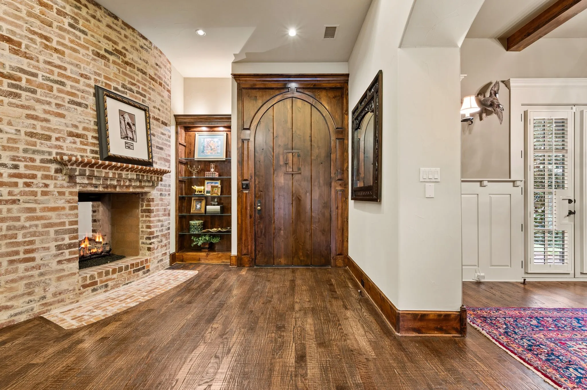 The charming antique Chicago brick fireplace creates a warm and inviting atmosphere, welcoming you into the home with timeless character and charm.