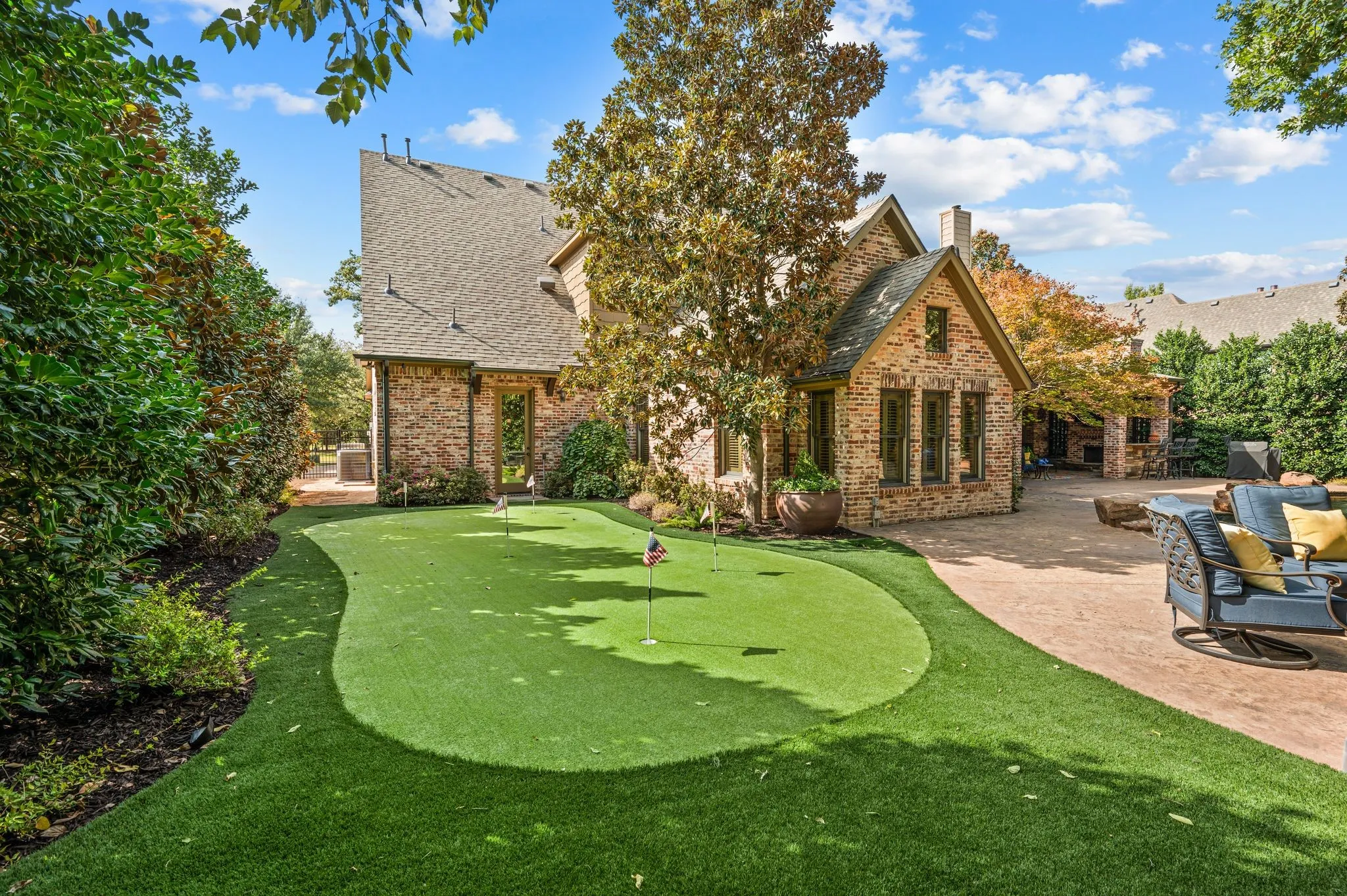 Perfect your short game in the privacy of your own backyard with a personal putting green, offering a fun and relaxing retreat for golf enthusiasts of all skill levels.