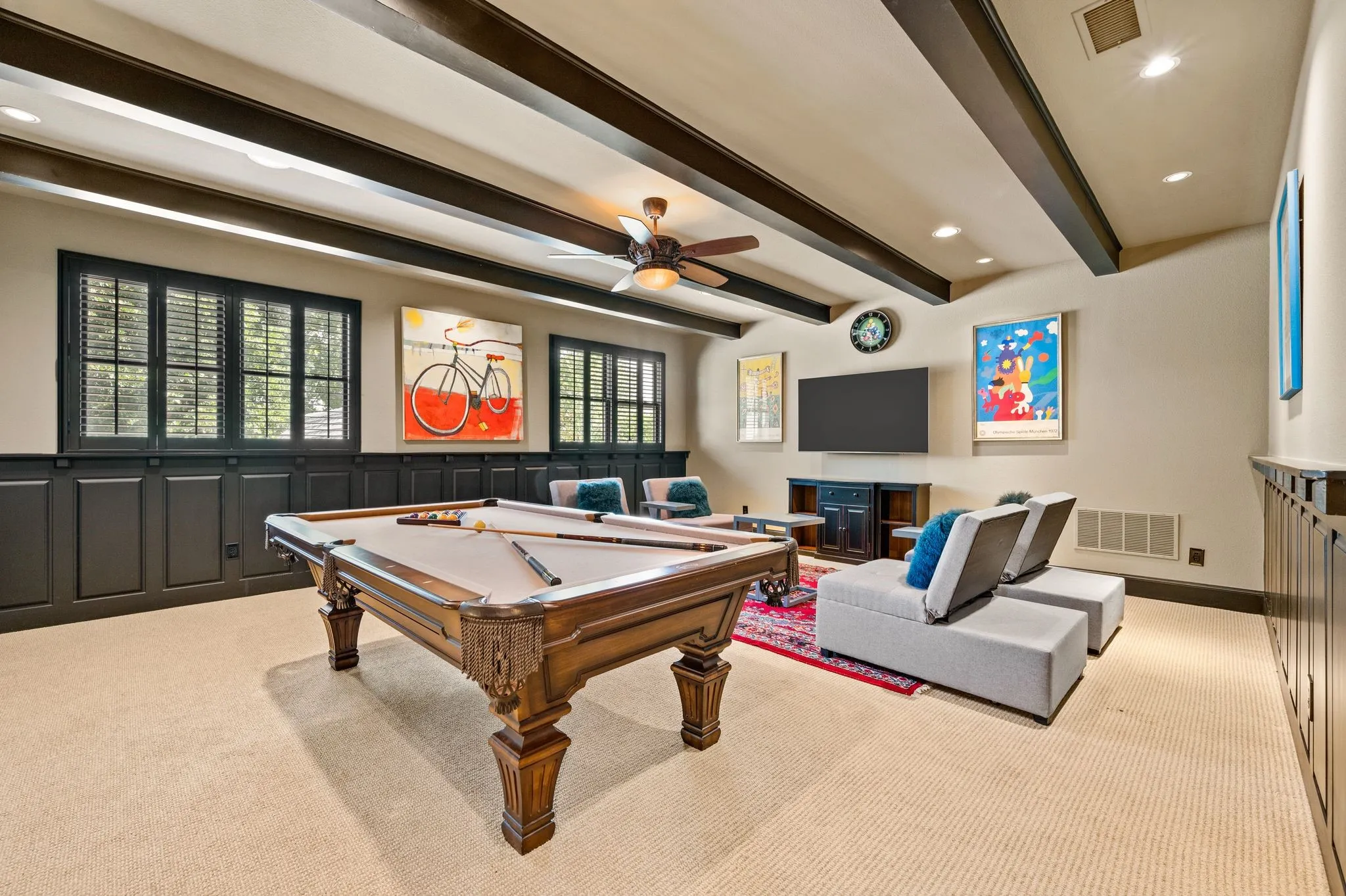 The spacious upstairs game room offers ample room for a pool table and dedicated gaming area, complemented by a convenient wet bar and beverage station—perfect for entertaining family and friends.