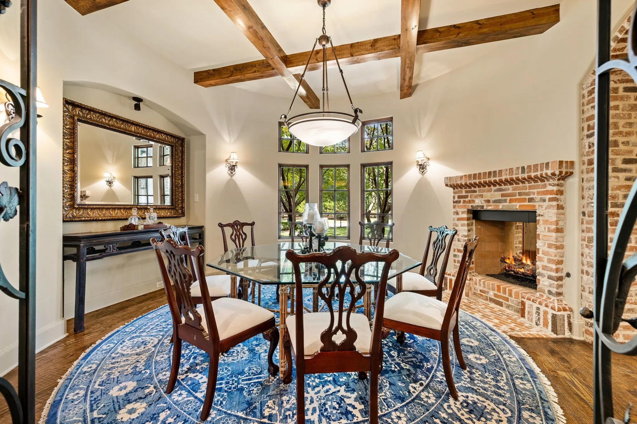 This charming circular dining area, complemented by a beautiful see-through fireplace, creates a warm and inviting setting for intimate family gatherings and memorable meals.