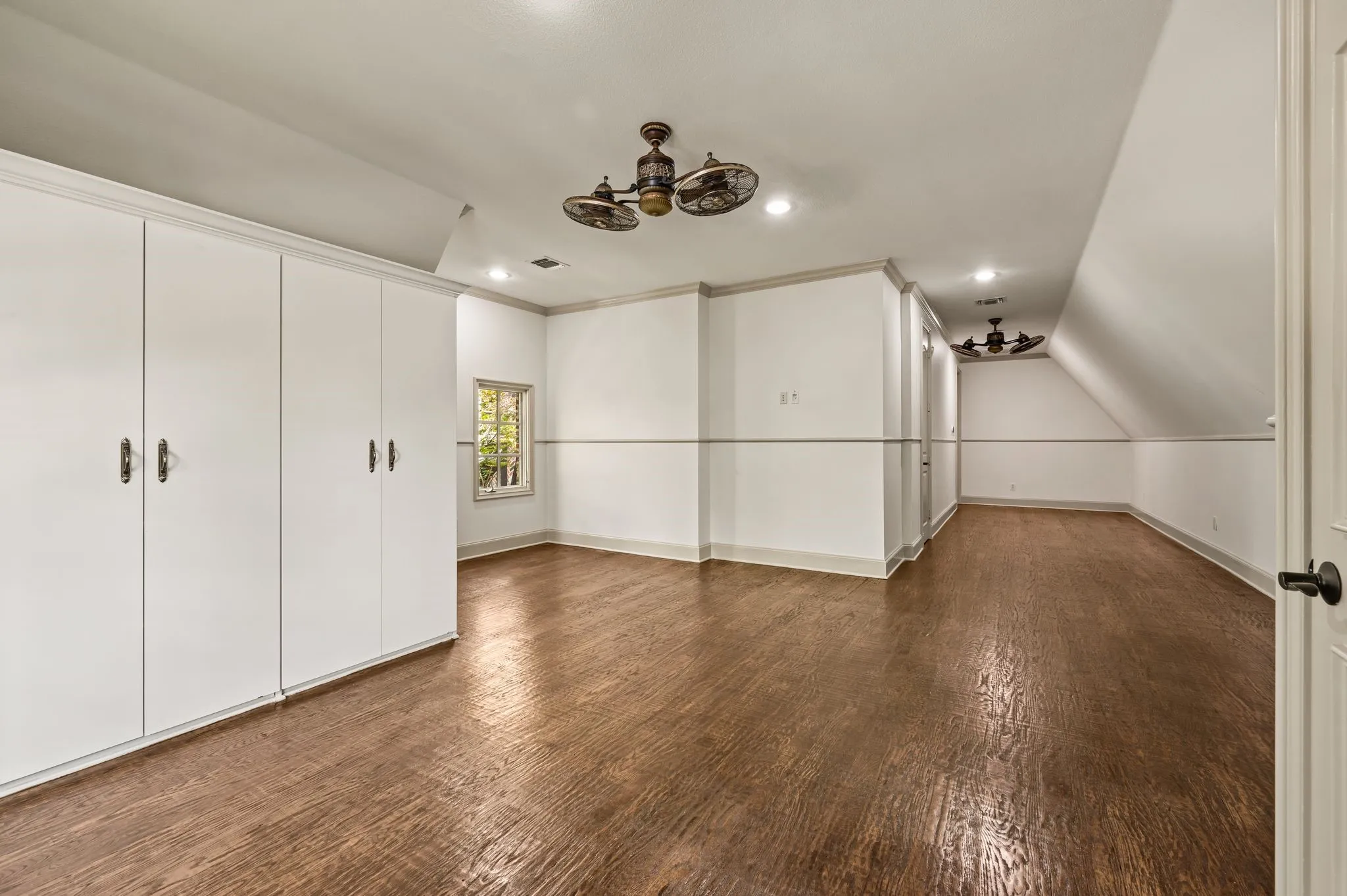 This spacious fifth bedroom offers exceptional versatility, featuring a Jack-and-Jill-style bath, walk-in closet, additional built-in cabinetry for storage, and a dedicated sitting area ideal for a desk or gaming space. Its generous size and flexible layout make it perfect for a bedroom, home office, or multipurpose retreat.
