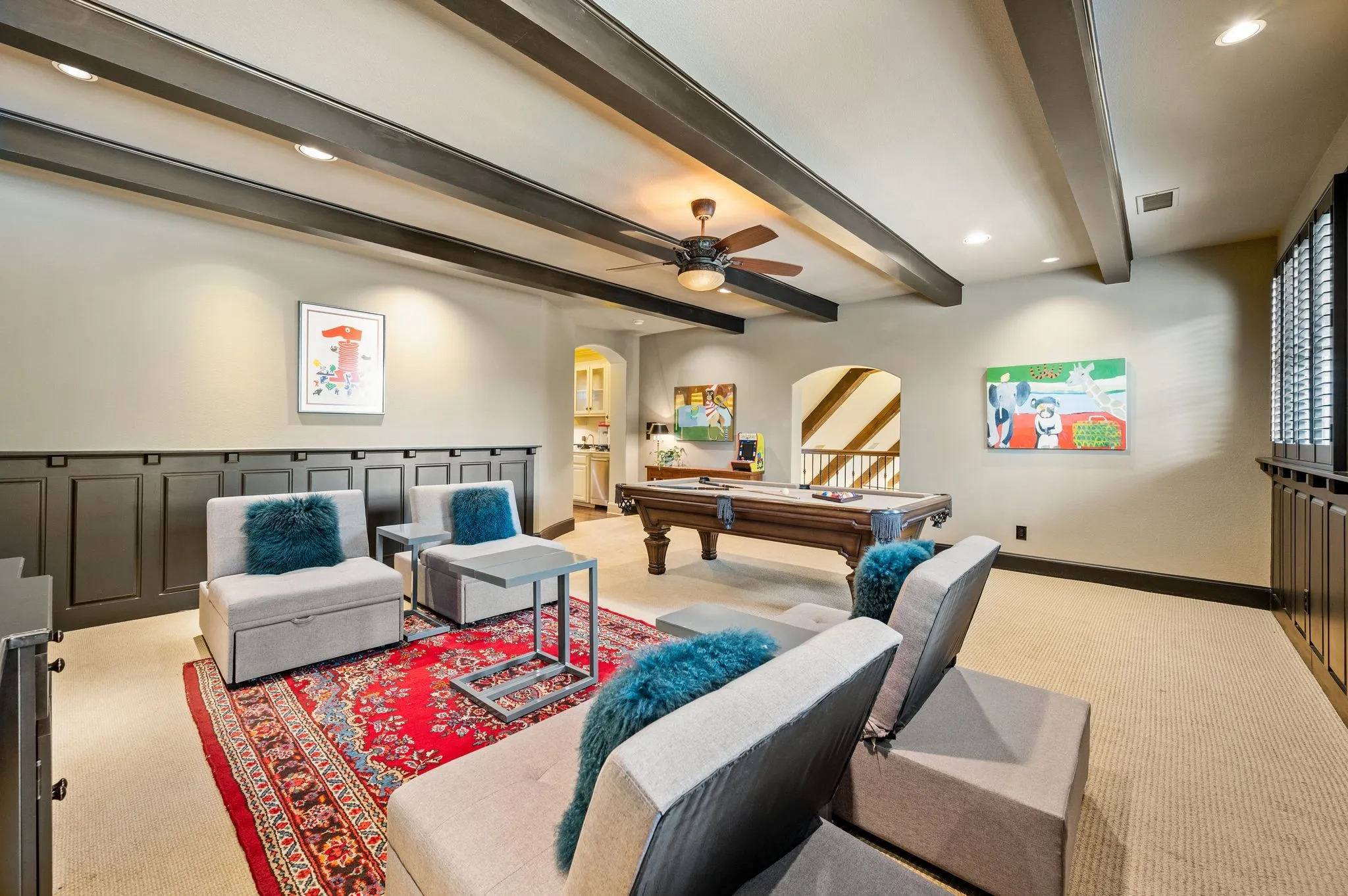 The spacious upstairs game room offers ample room for a pool table and dedicated gaming area, complemented by a convenient wet bar and beverage station—perfect for entertaining family and friends.