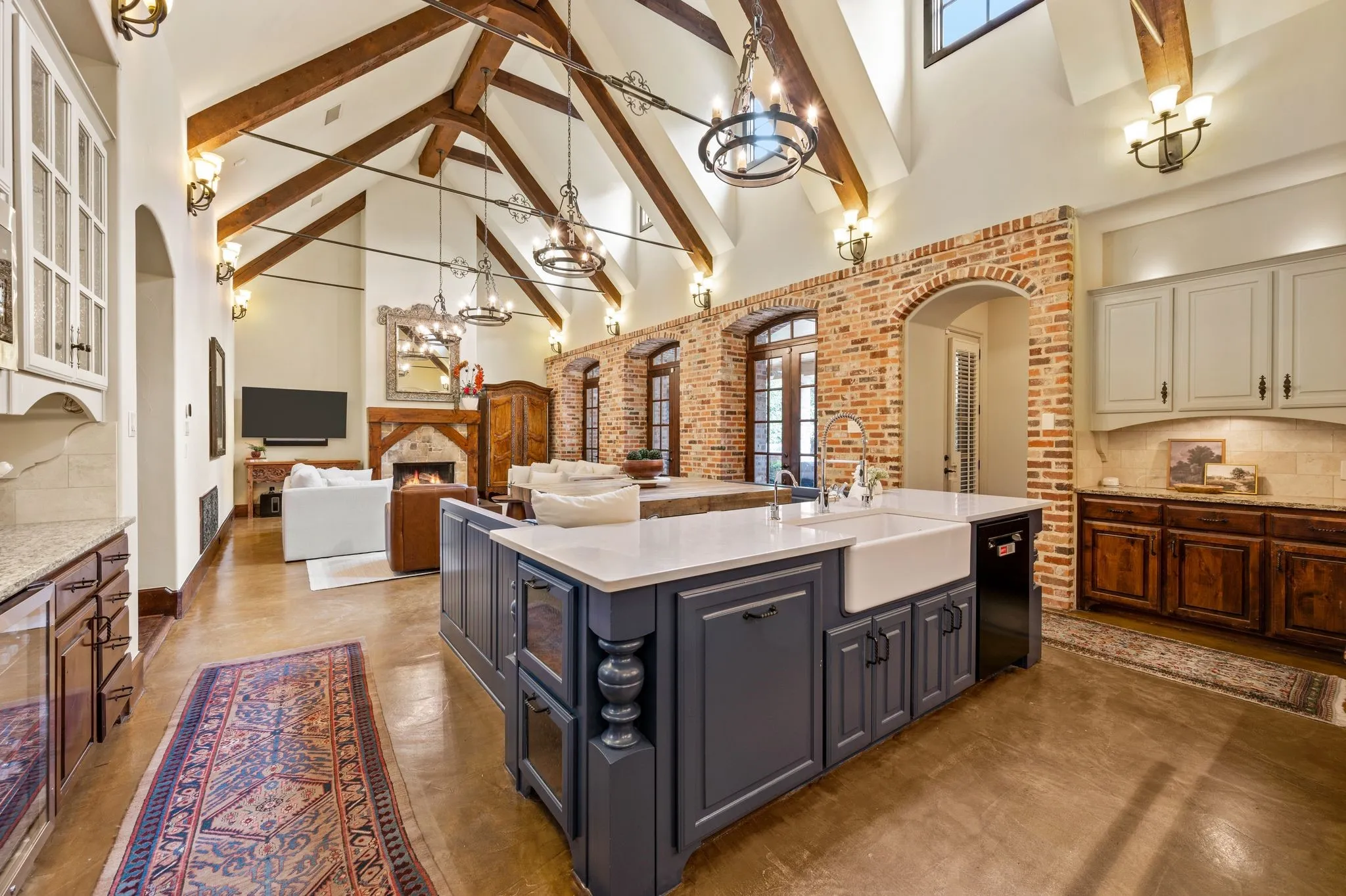 A spacious kitchen island with a farmhouse sink offers ample room for meal preparation and cooking, all while enjoying open views of the great room.