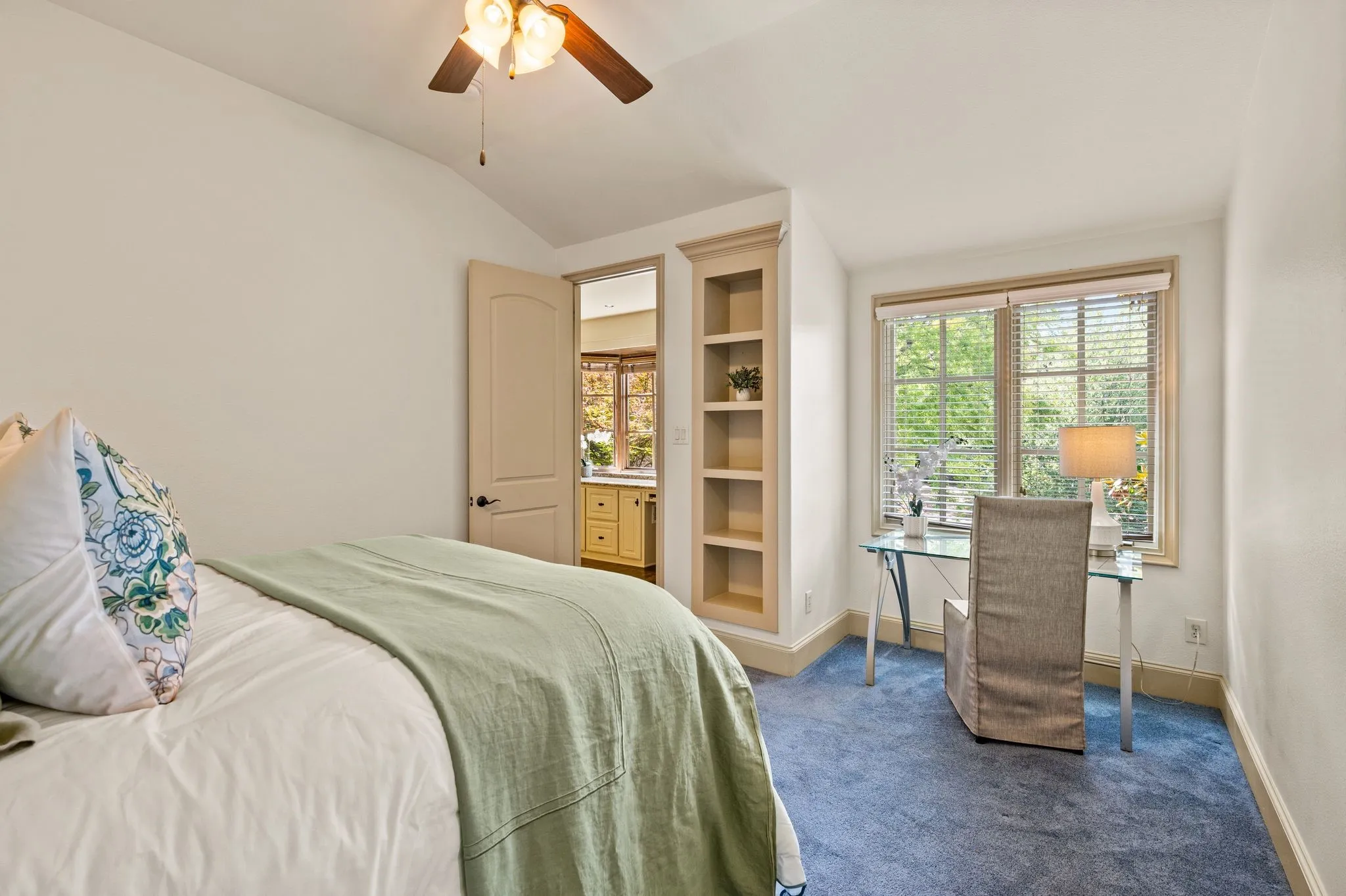 One of three spacious upstairs bedrooms, featuring an expansive window that fills the room with natural light, a private ensuite bath, and a generous walk-in closet.