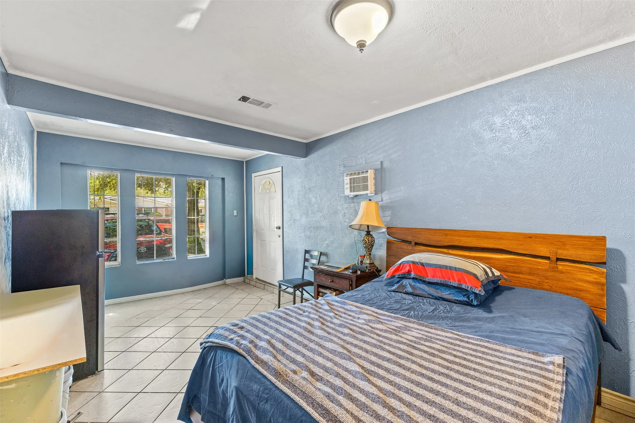 Ceramic tile flooring, multi-pane windows, and a flush-mount ceiling light fixture