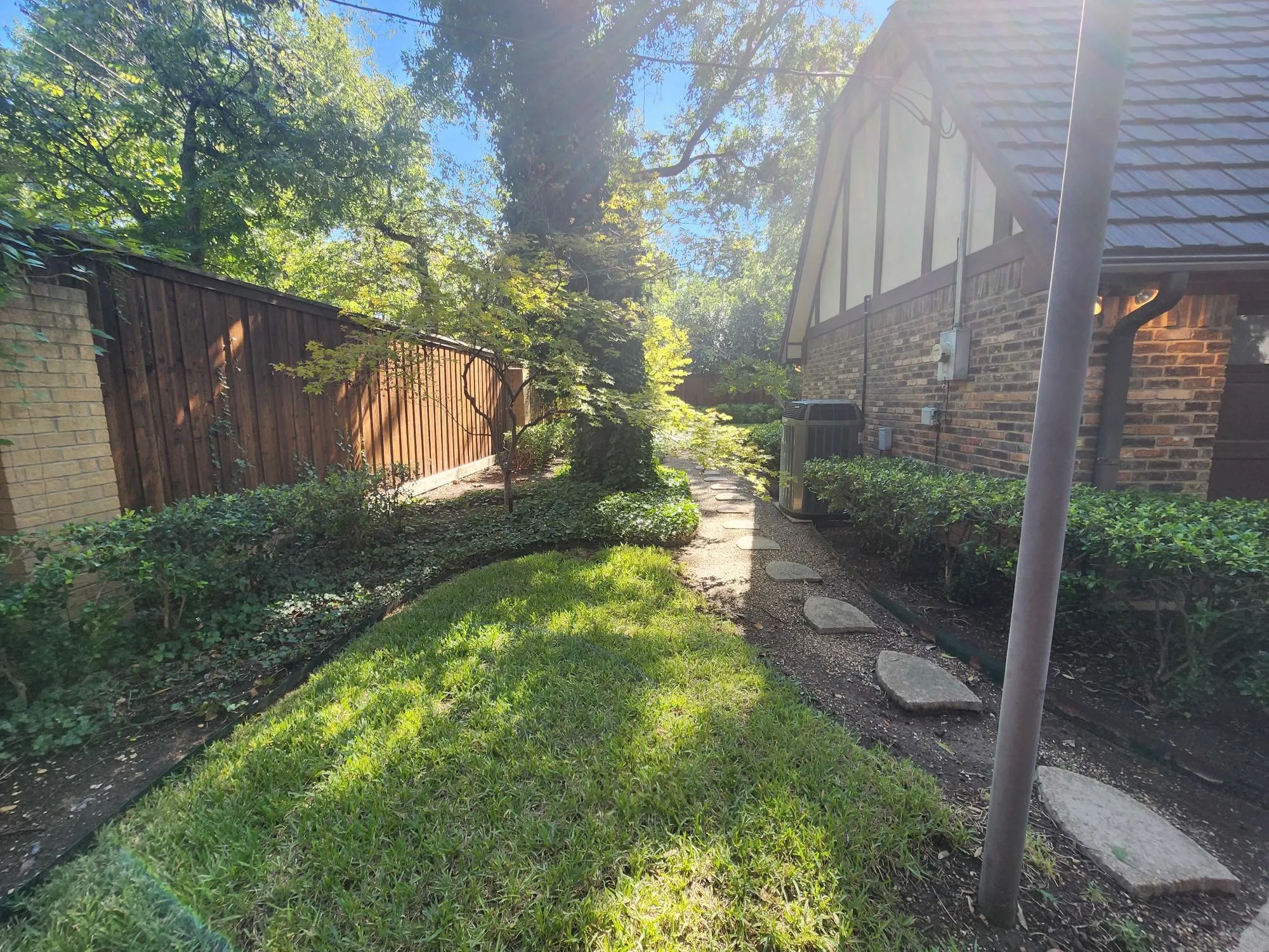 Walk around to the backyard from the driveway.