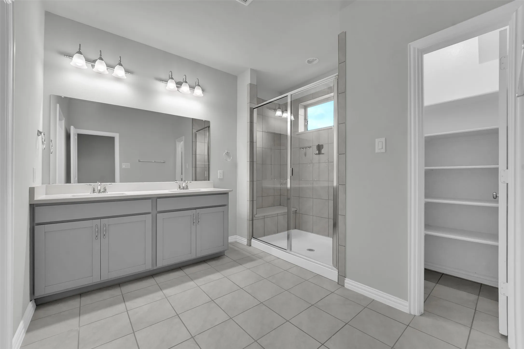 Dual vanity with undermount sinks and light-colored countertops
