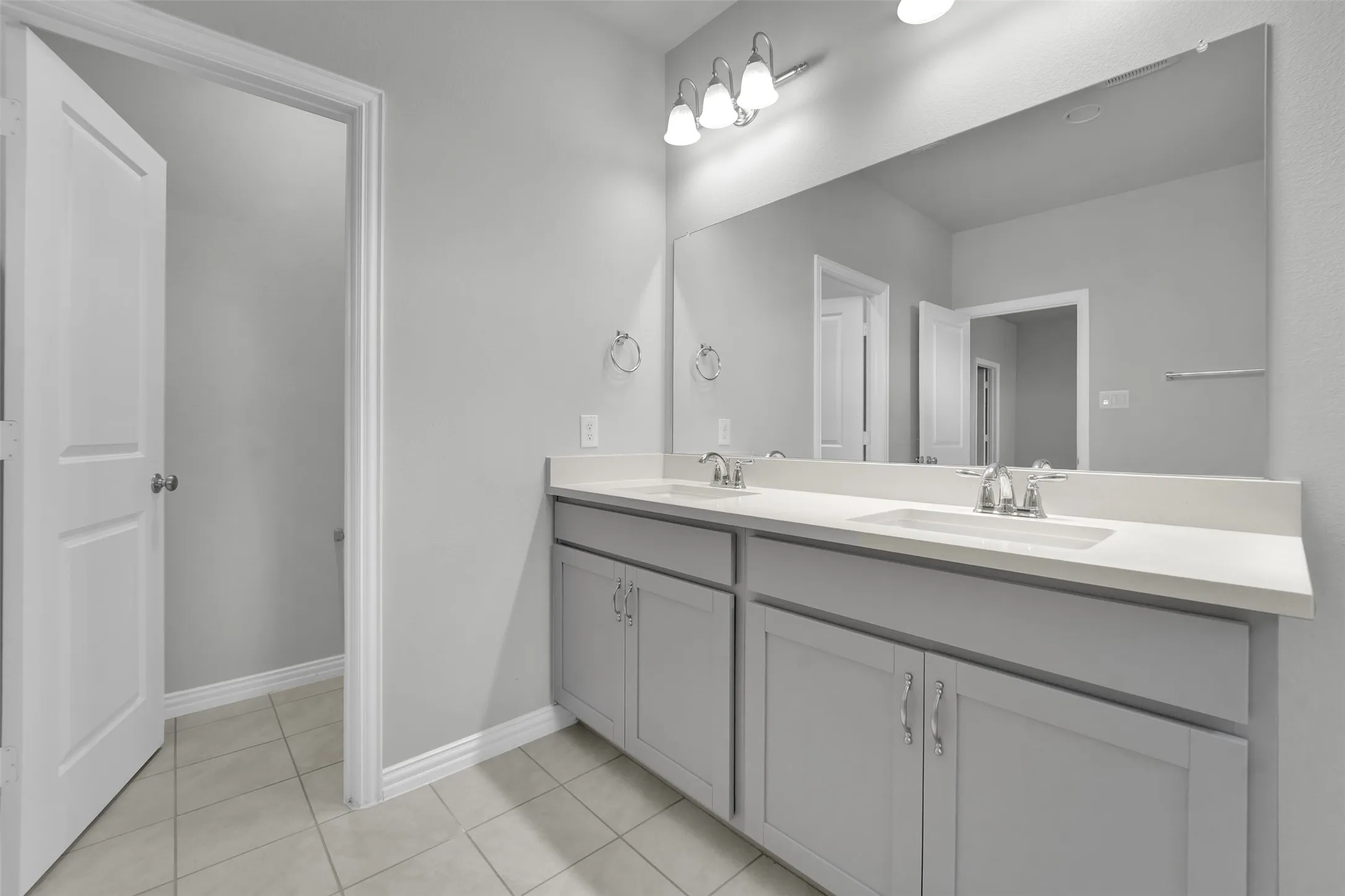 Dual vanity with white countertops and undermount sinks